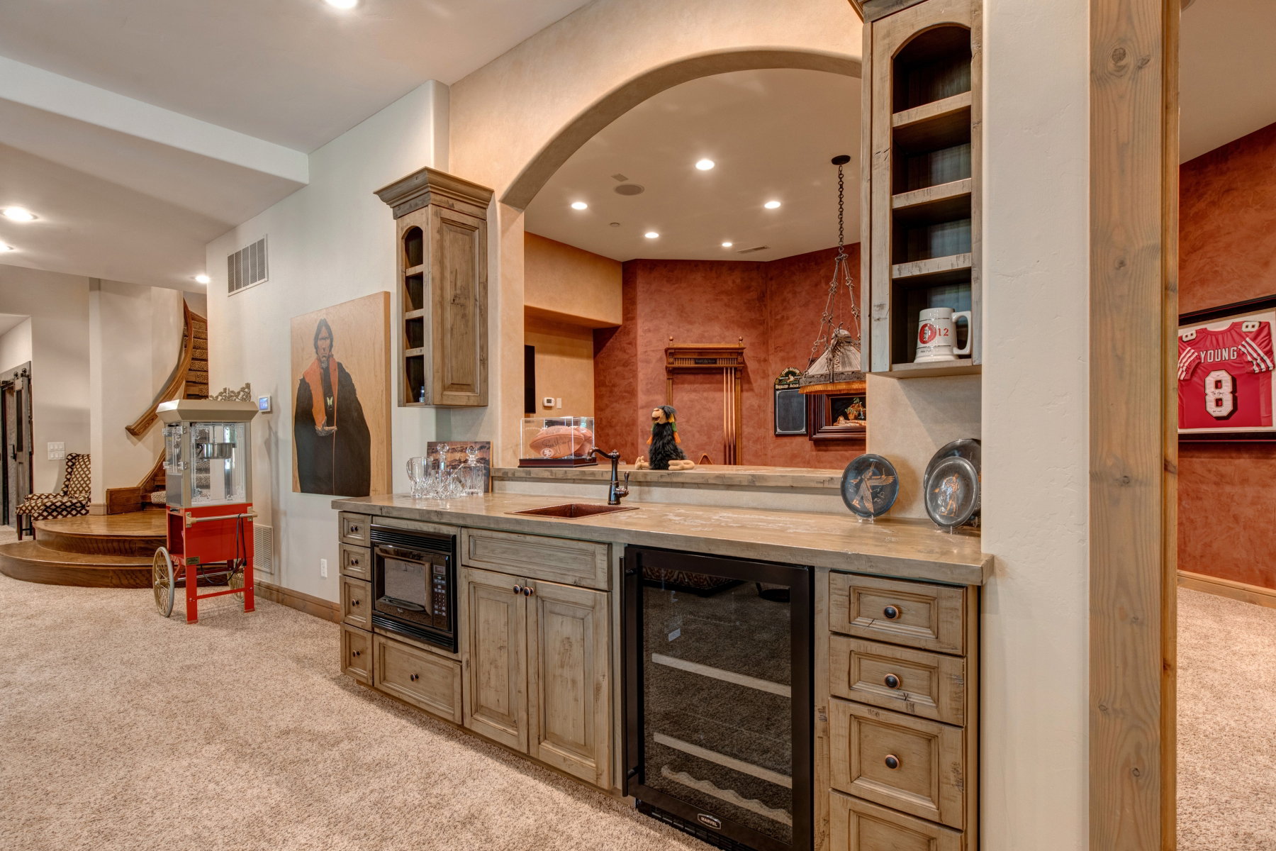 Custom wet bar featuring a built-in microwave, beverage cooler, and integrated sink