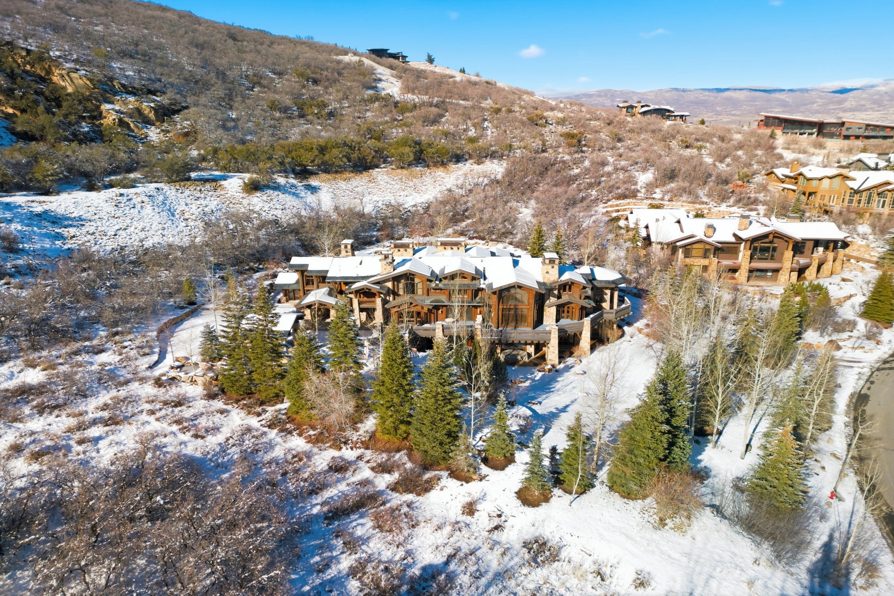 Expansive mountain property featuring a multi-level residence with extensive natural wood and stone detailing