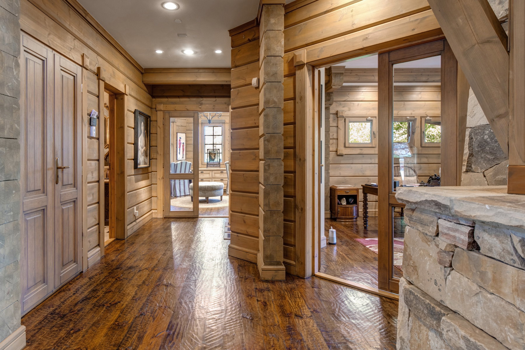 Rustic interior hallway featuring rich wood-finish flooring