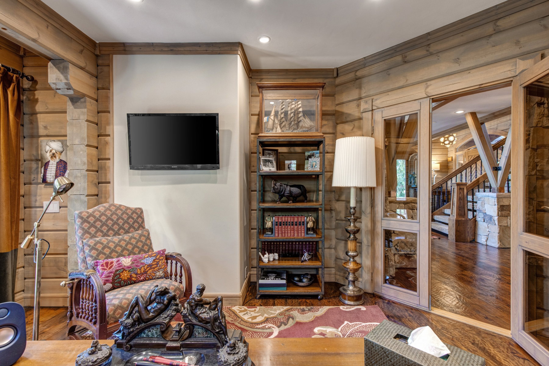 Paneled wood walls featuring integrated shelving