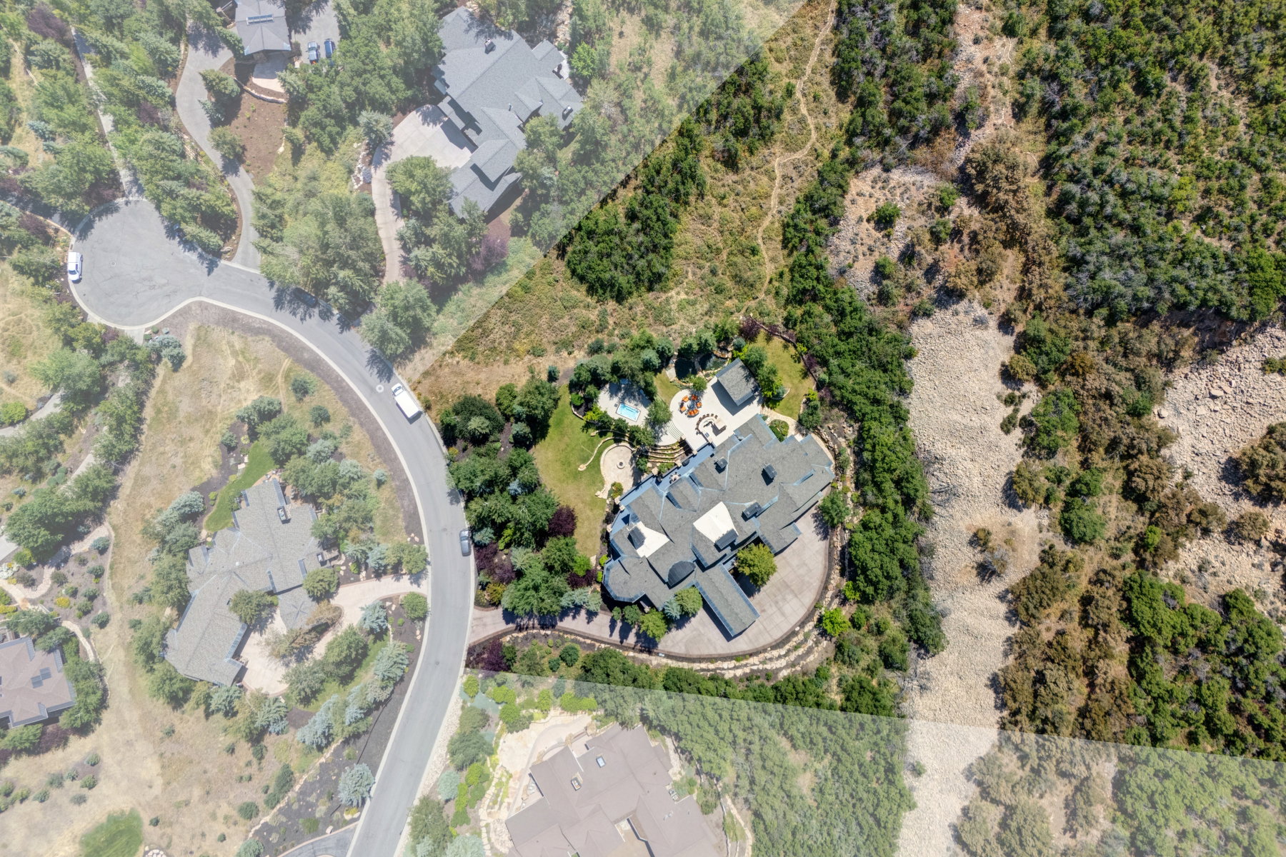 Extensive property with a large main residence, circular driveway, and an outdoor swimming pool