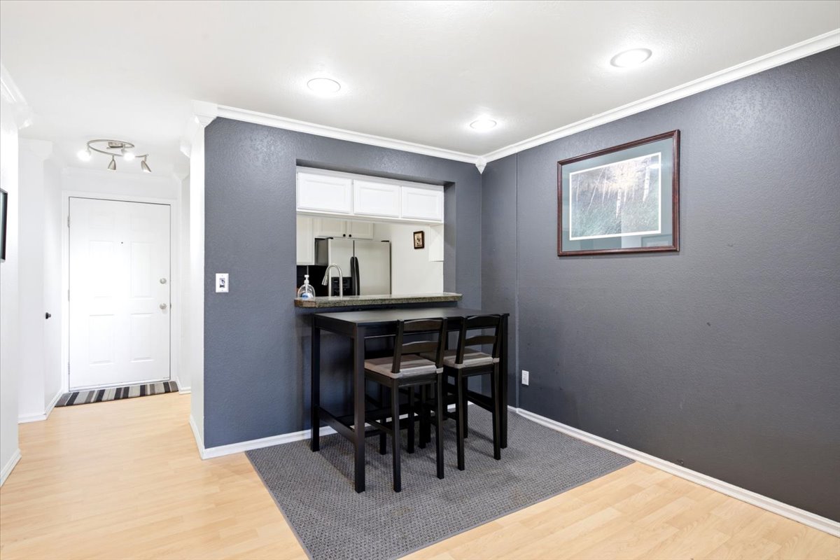 Dining area featuring a pass-through window to the kitchen.