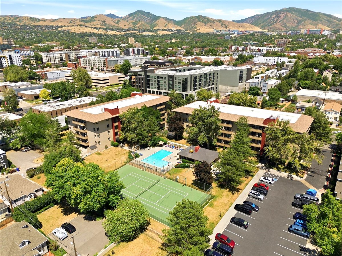Aerial perspective showcasing a tennis court, and an outdoor swimming pool