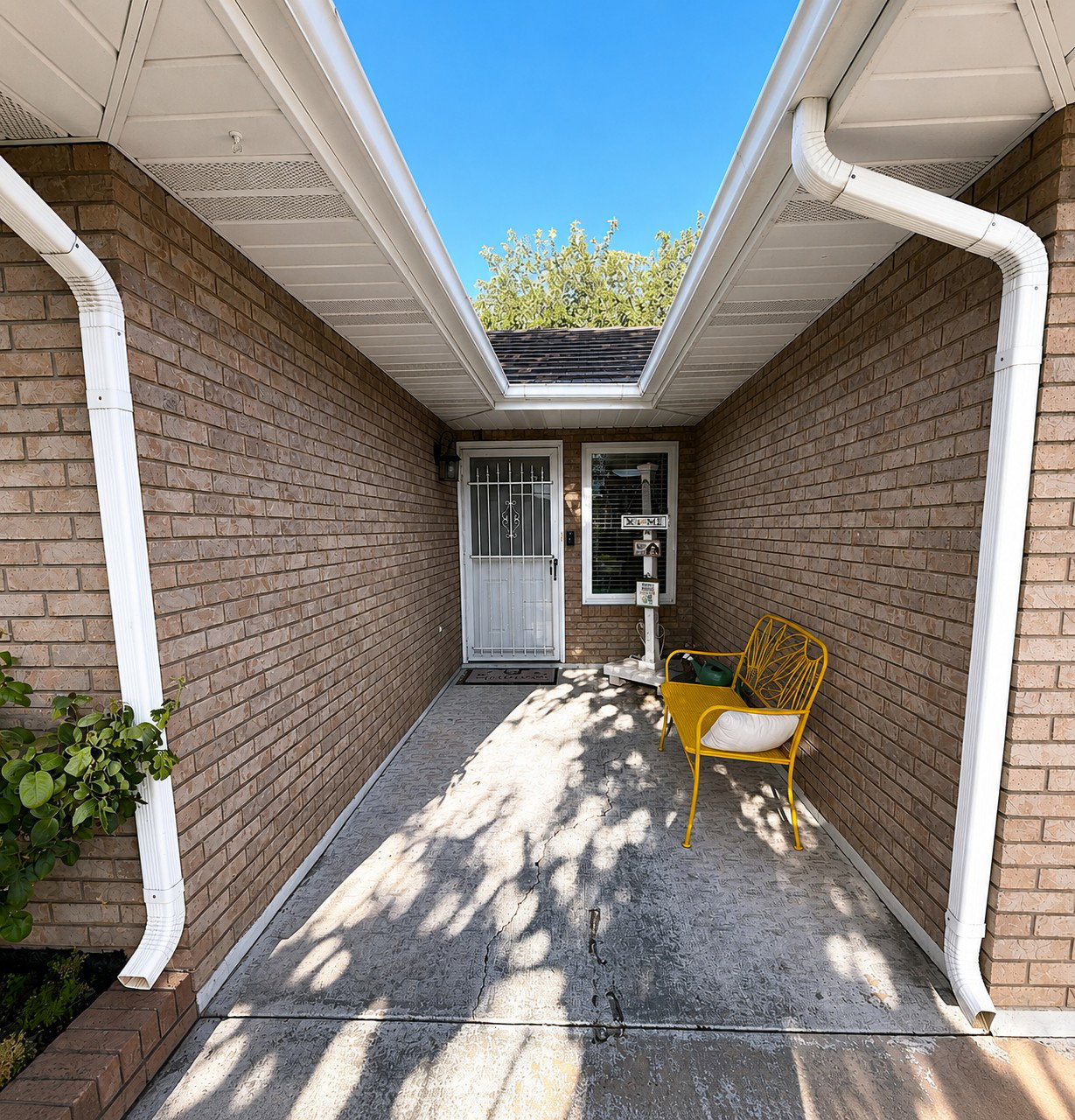 Brick exterior with white soffit and gutter system