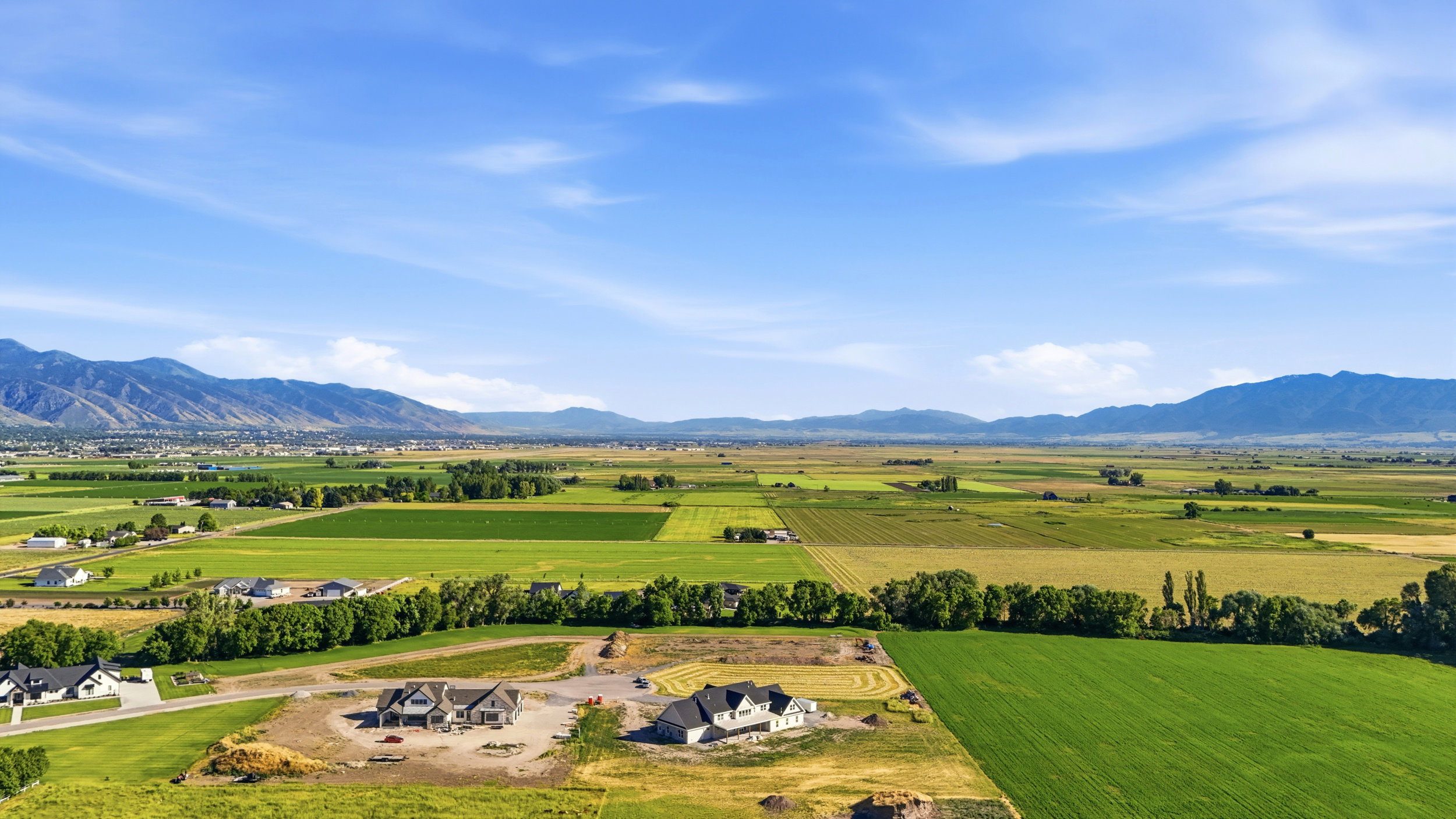 Expansive valley setting with agricultural land and distant mountains