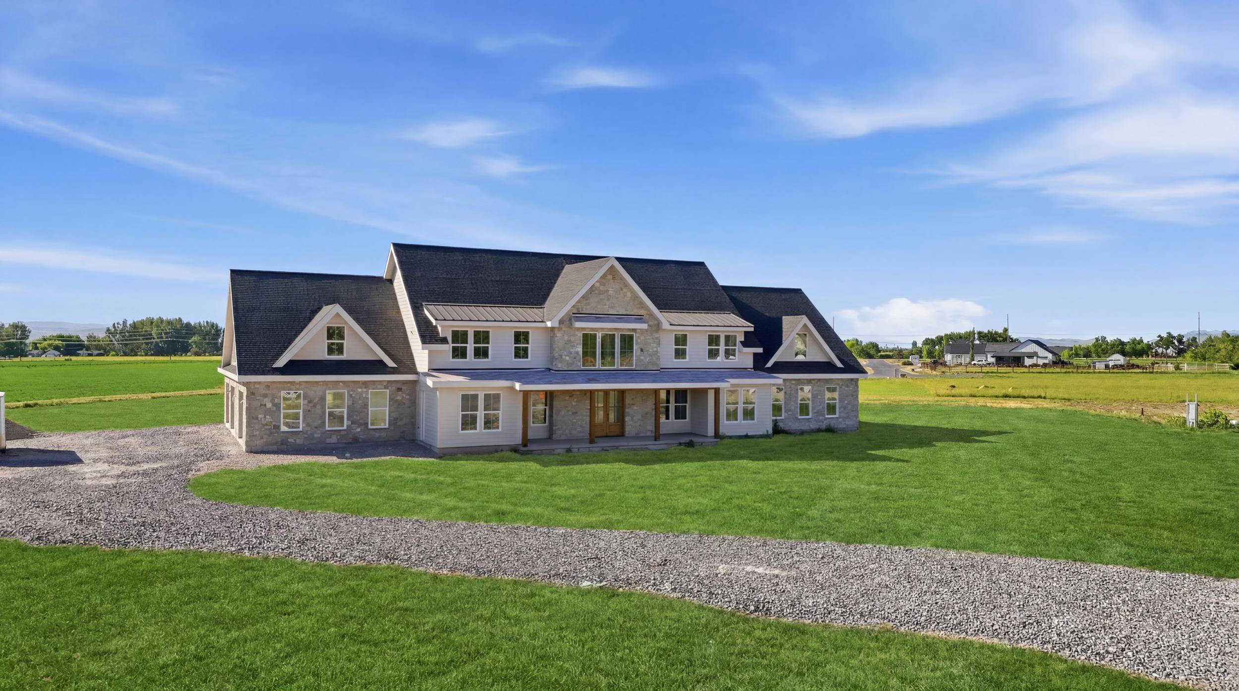 Stone and siding exterior with multiple gables and a covered front porch featuring wood columns