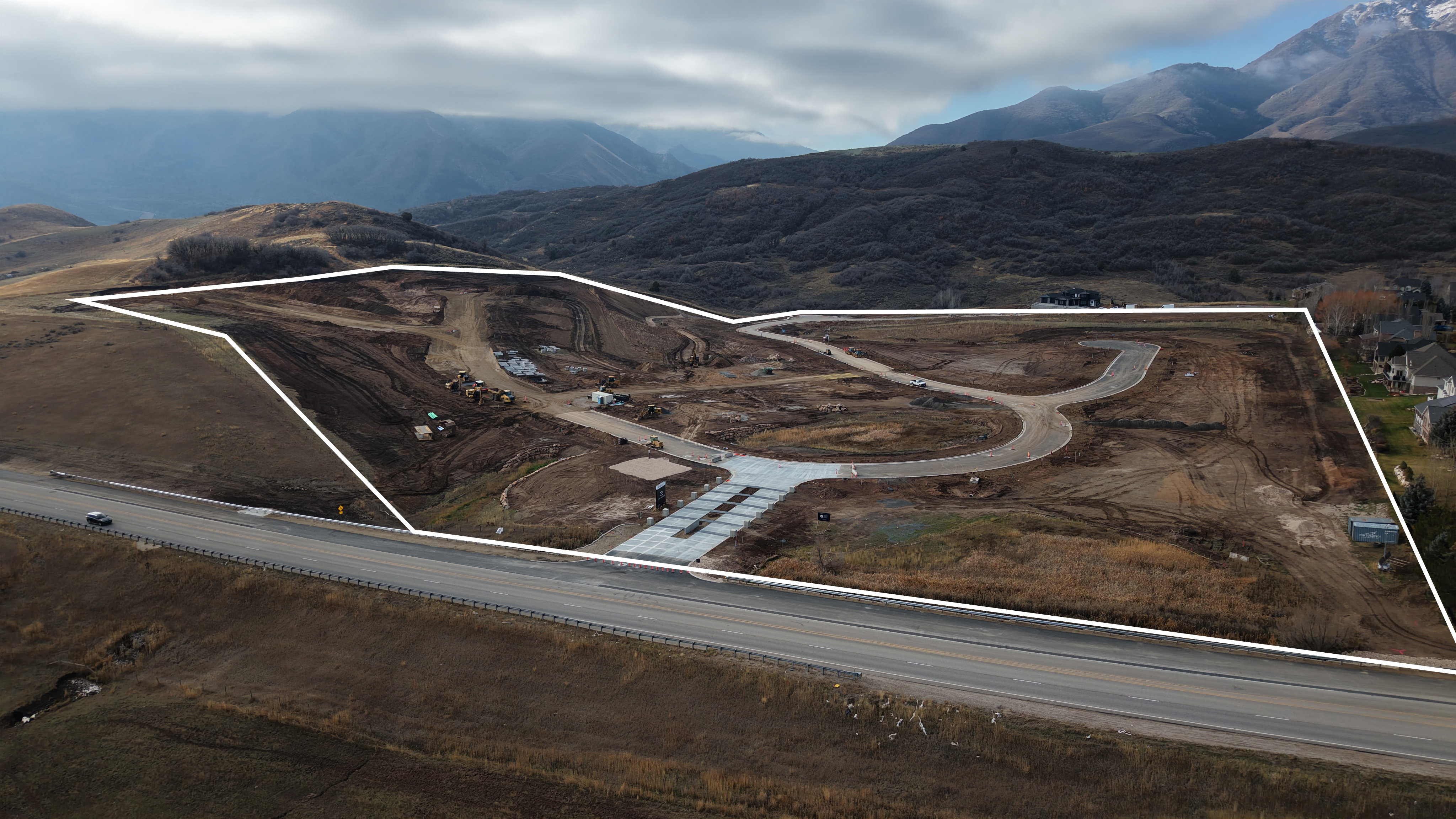 Developed land parcel featuring graded terrain, paved road frontage, and established internal roadways