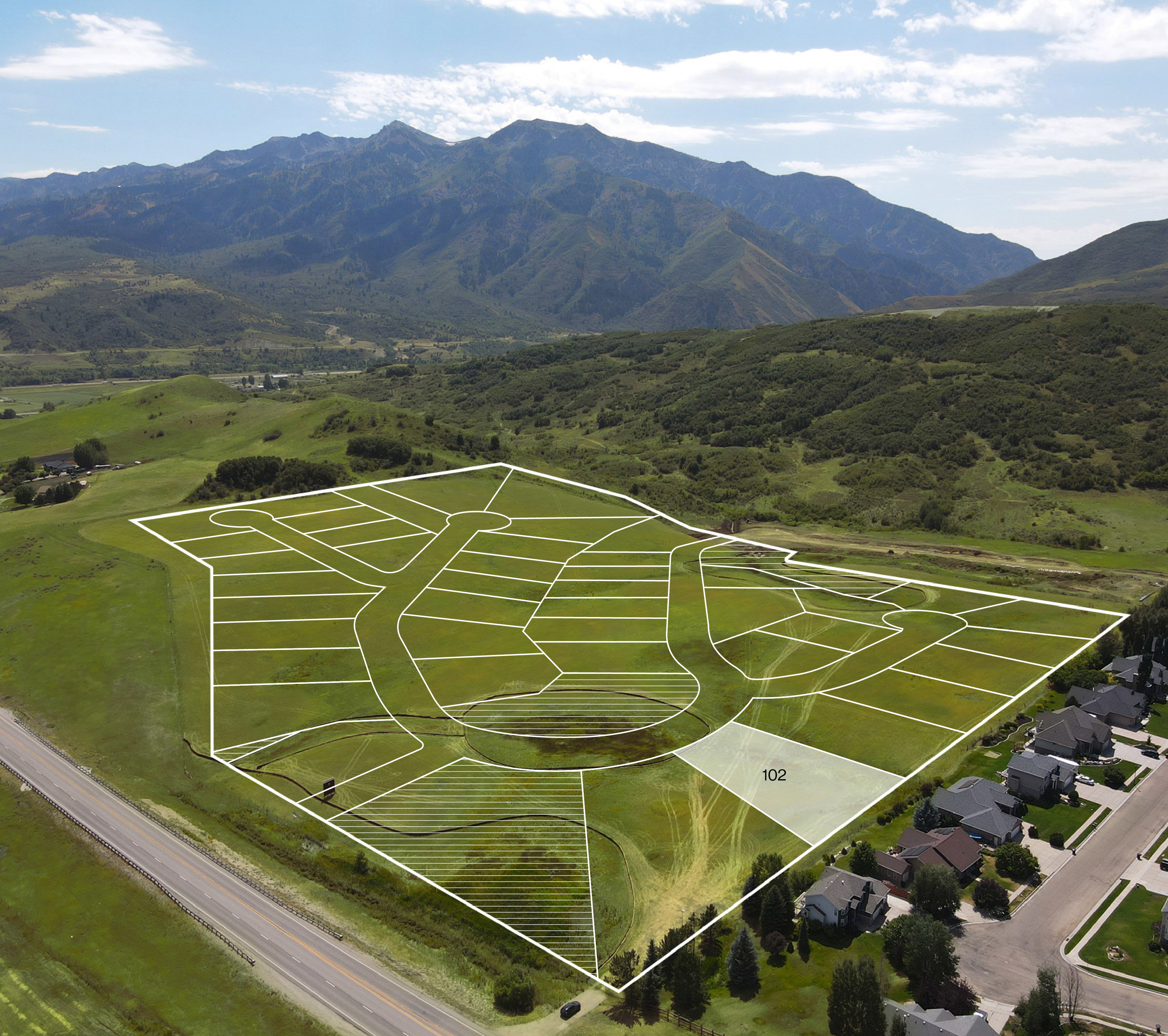 Aerial view highlighting a developing subdivision with delineated lots