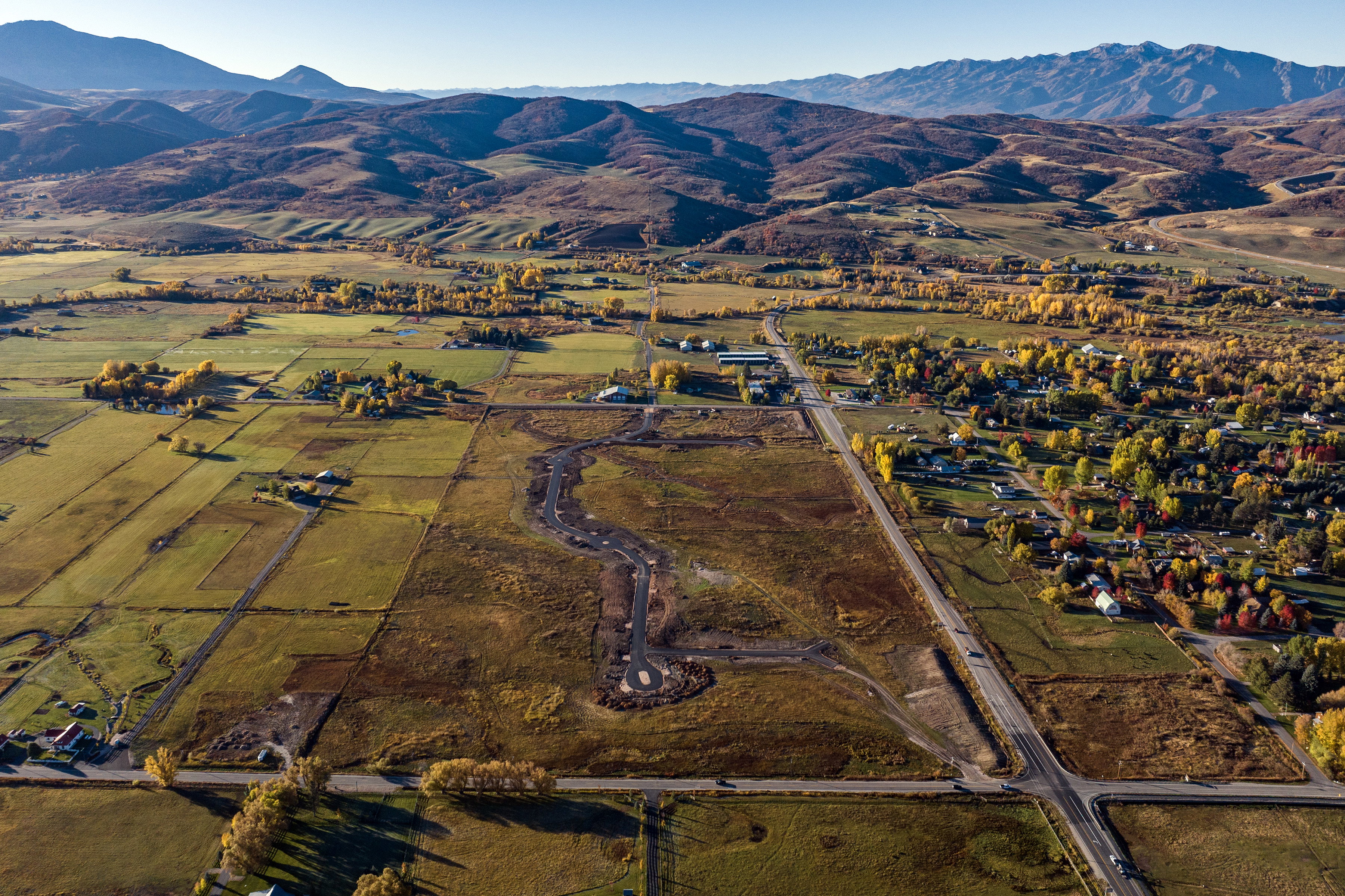 Expansive undeveloped land with visible road infrastructure and graded areas