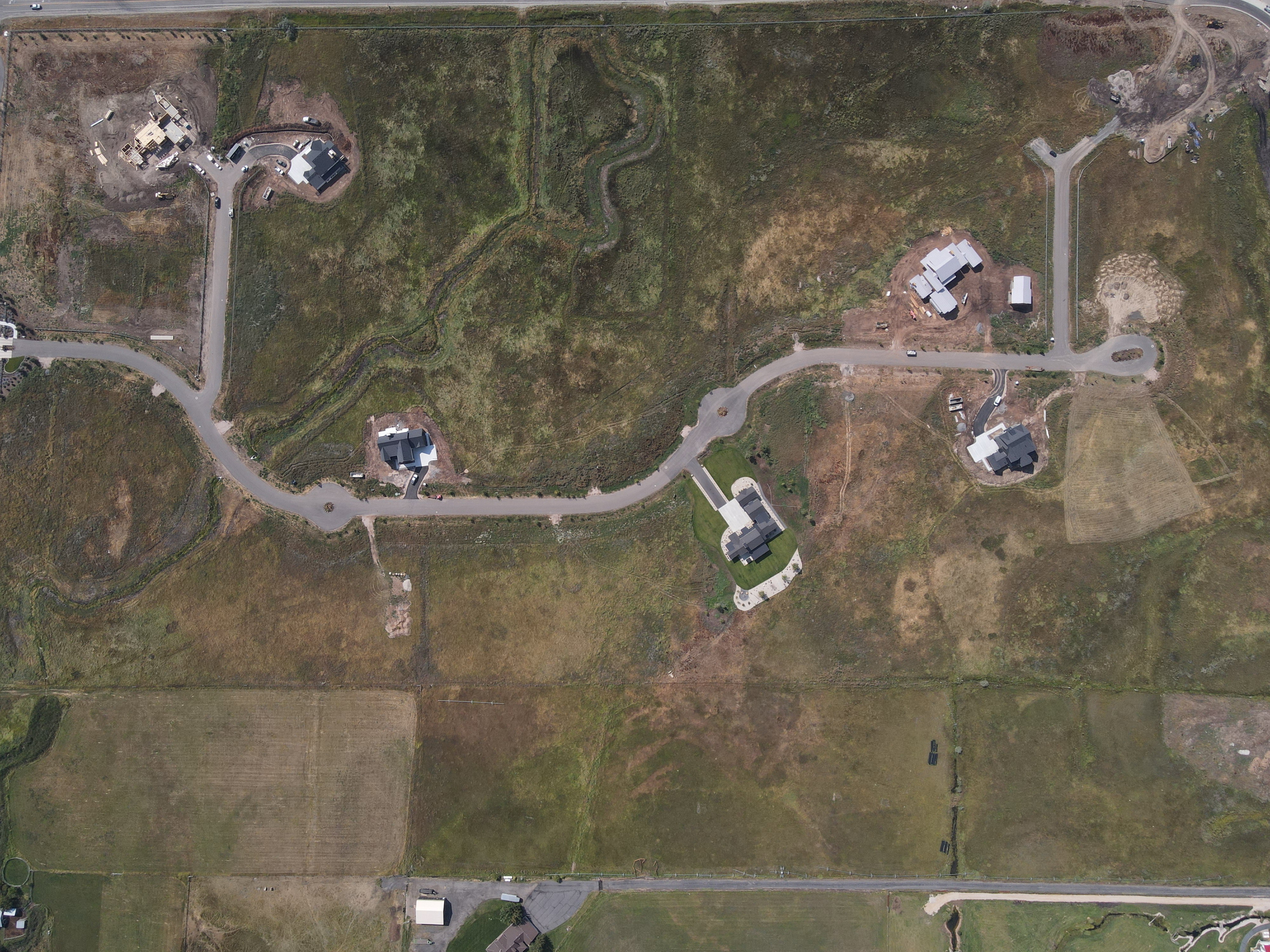Aerial Survey. Showing an undeveloped property with existing structures and access roads