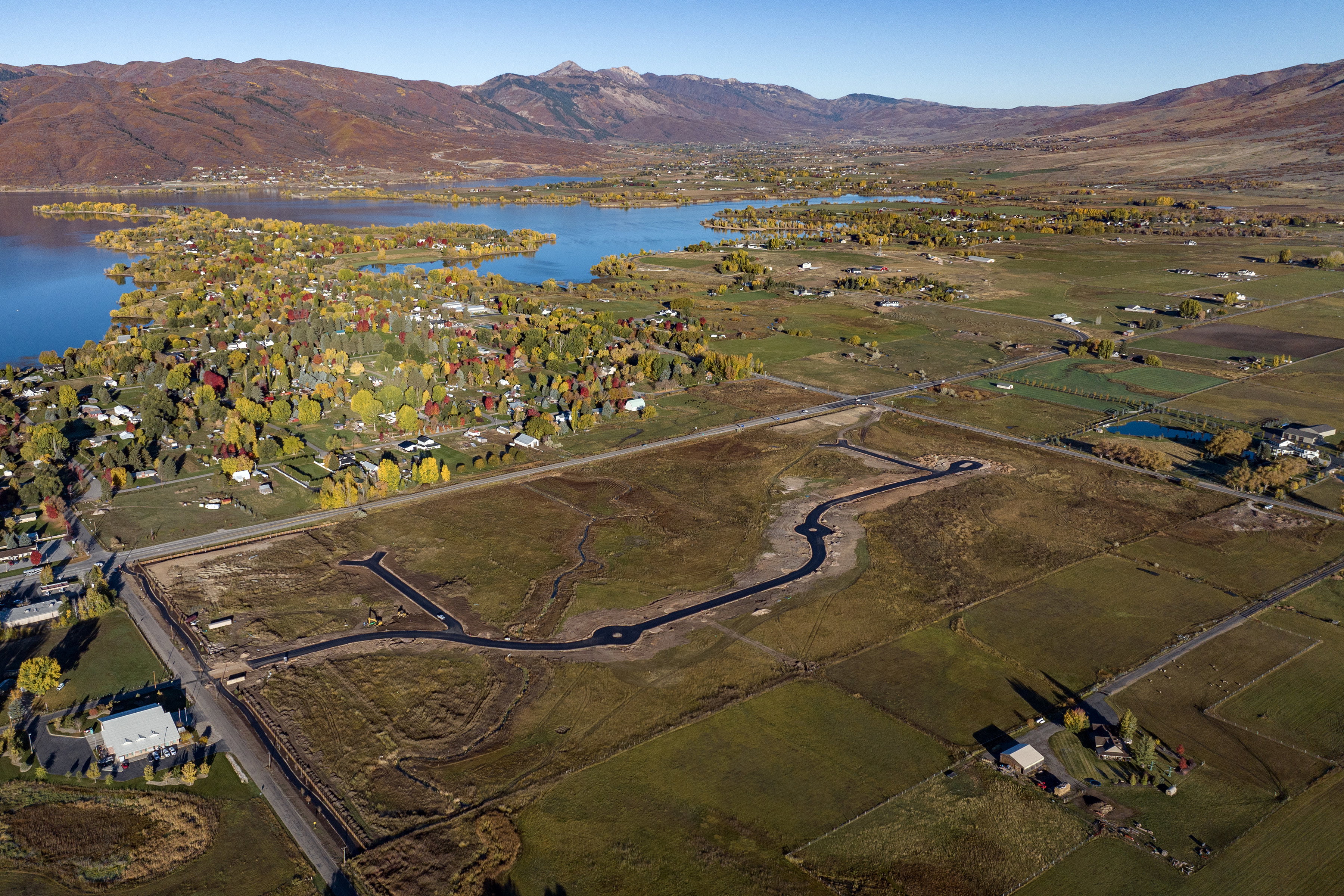 Expansive land parcel featuring new road infrastructure, established utility access, and surrounding natural landscape