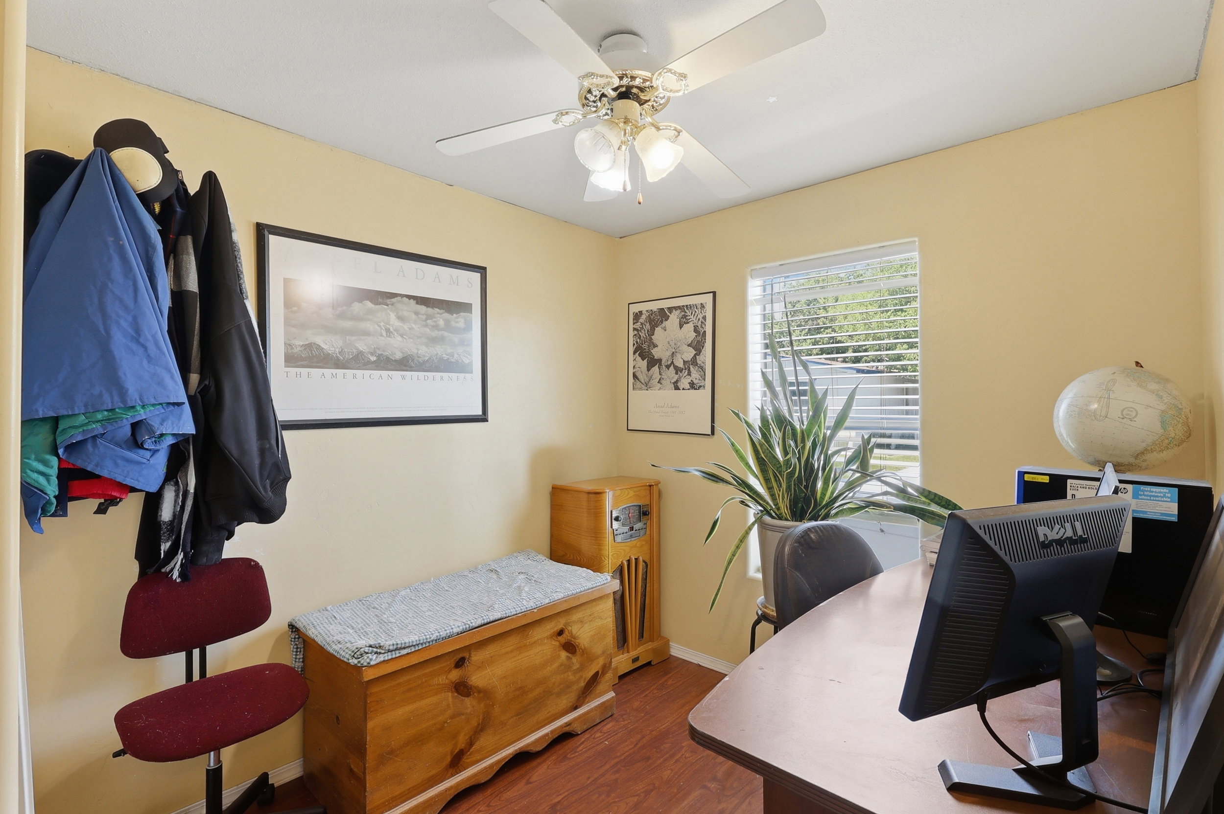 Interior room with wood-finish flooring and light yellow walls