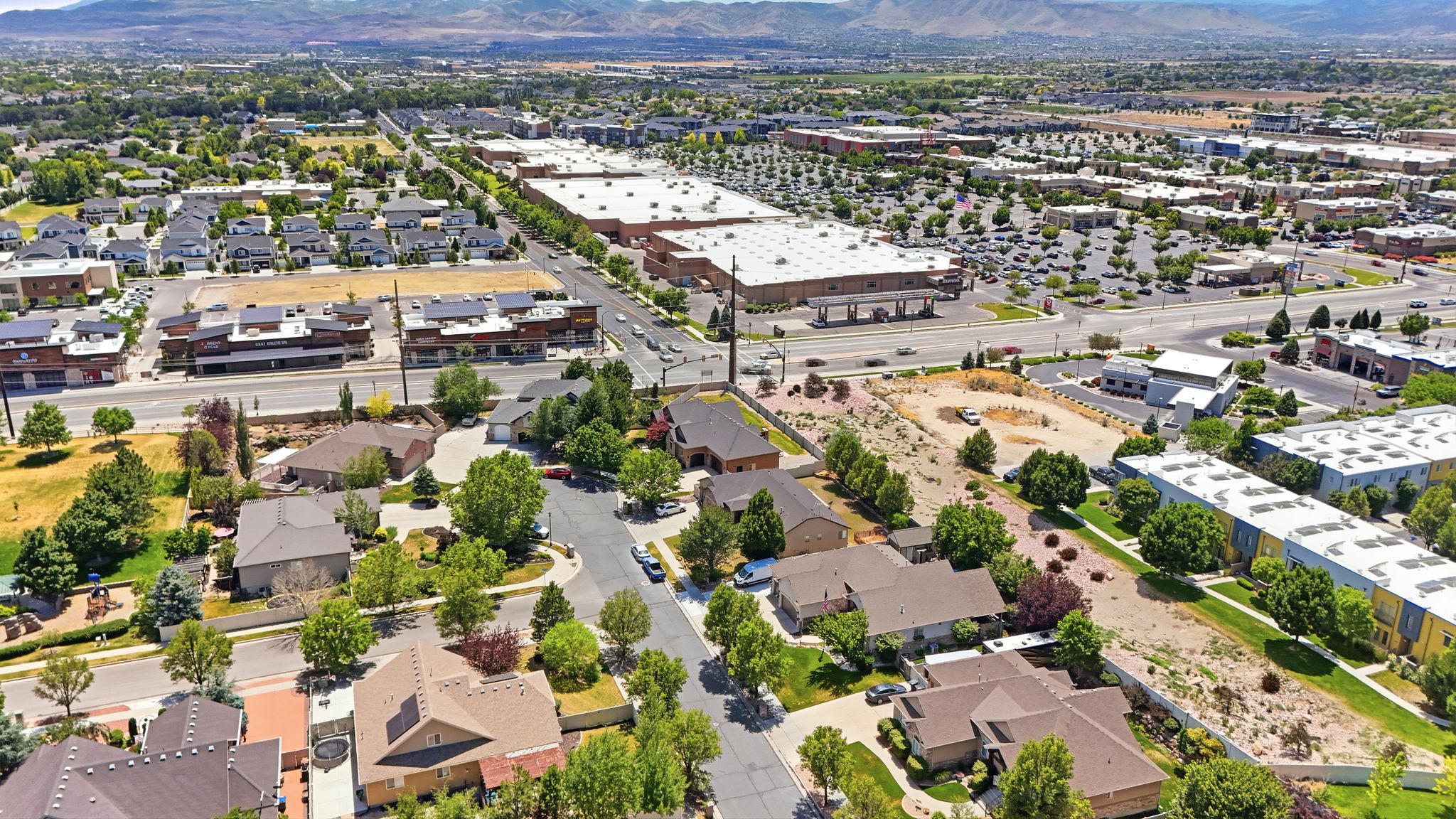 The District is close by. Aerial perspective showcasing a residential area with varied housing styles