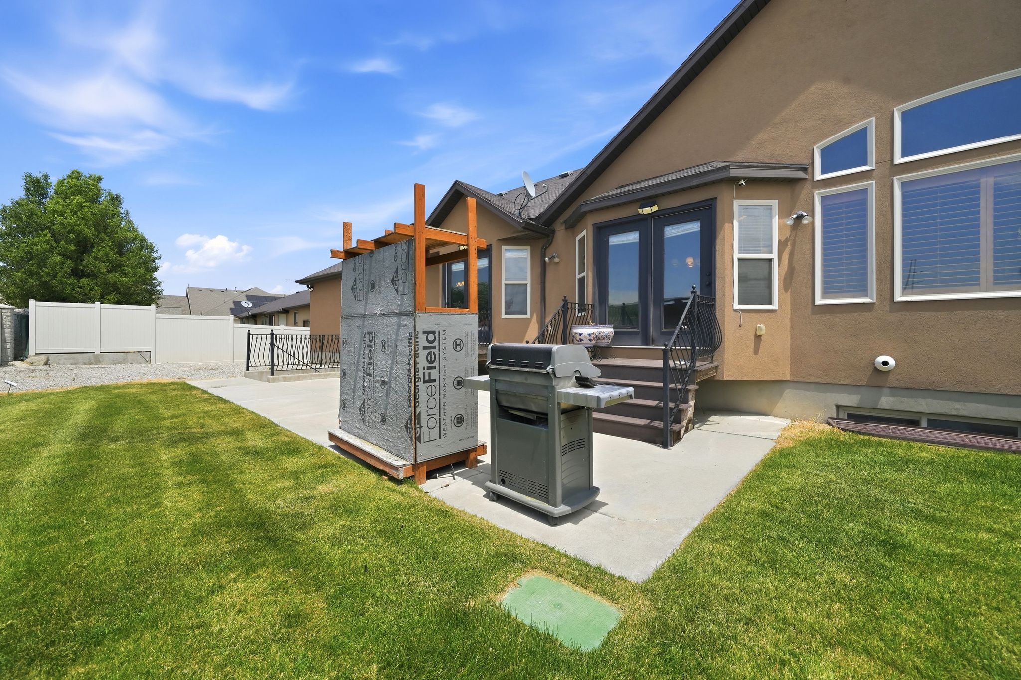 Expansive green lawn with a concrete patio