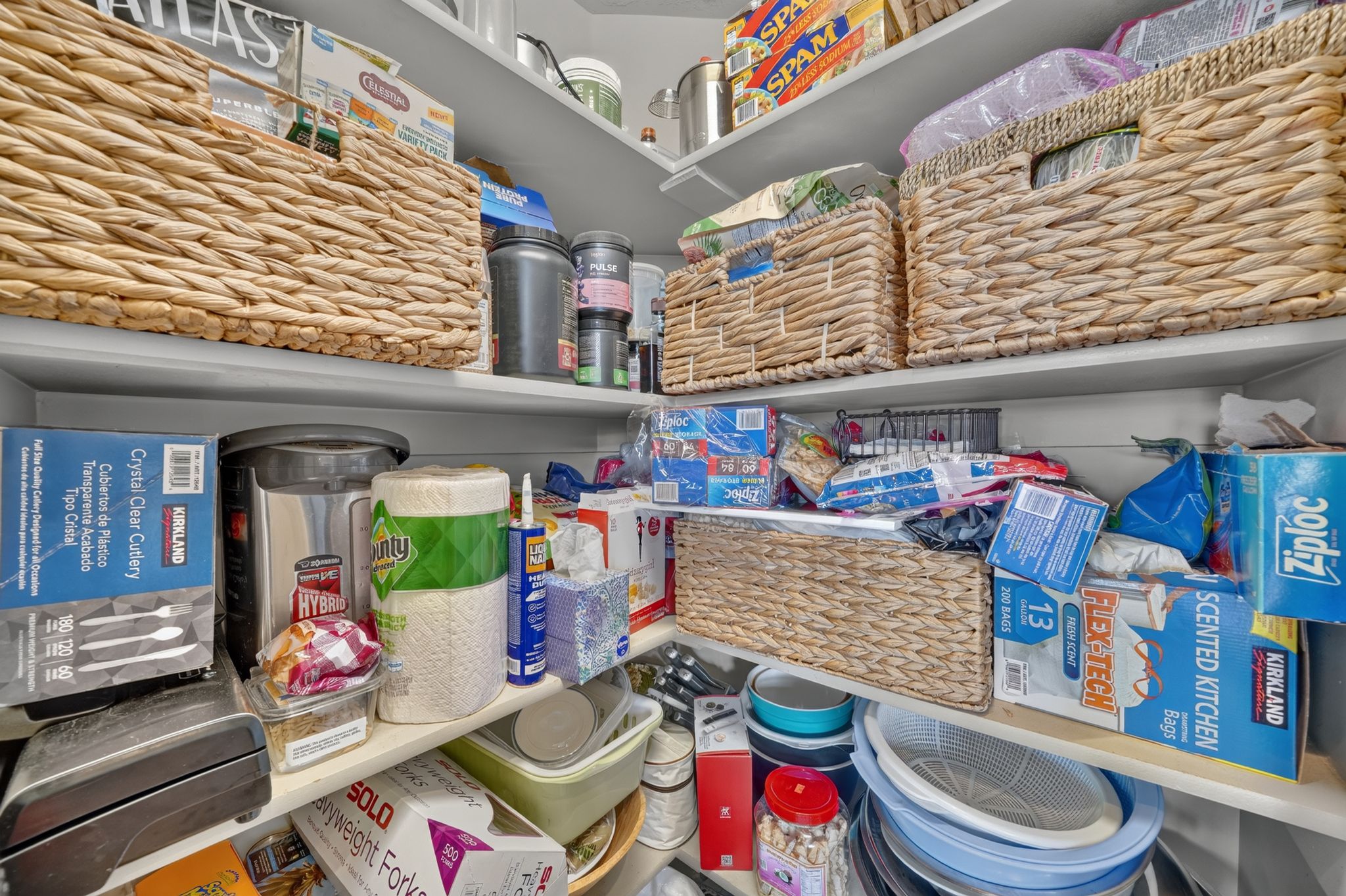 Corner pantry with multiple levels of built-in shelving, providing extensive storage capacity