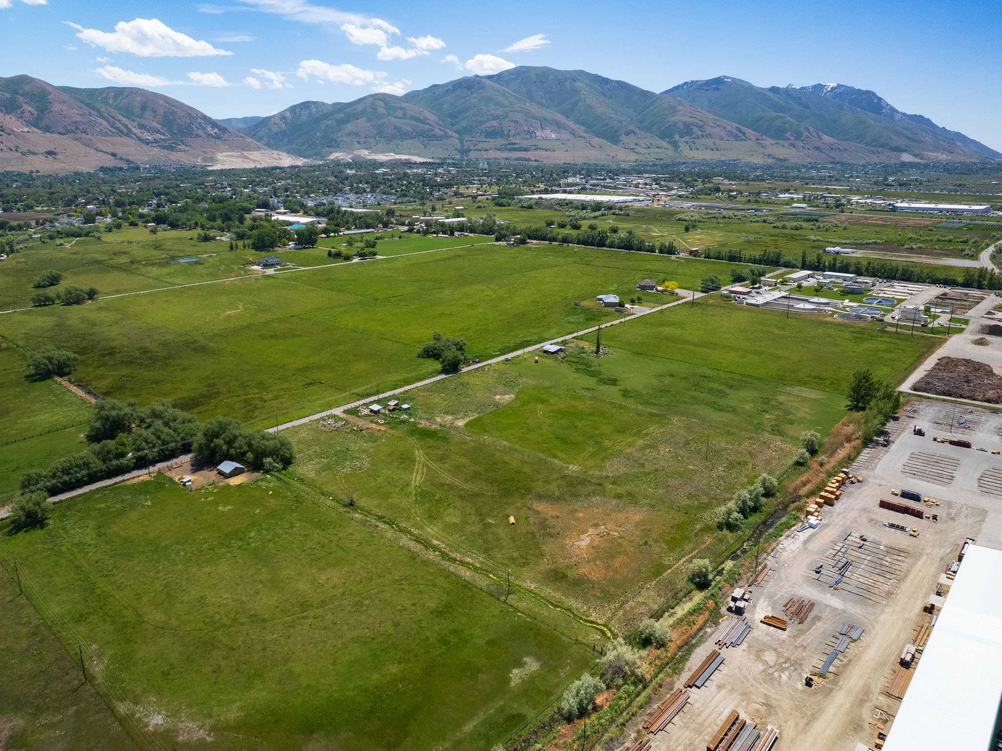 Expansive green fields with distant mountains forming a natural backdrop
