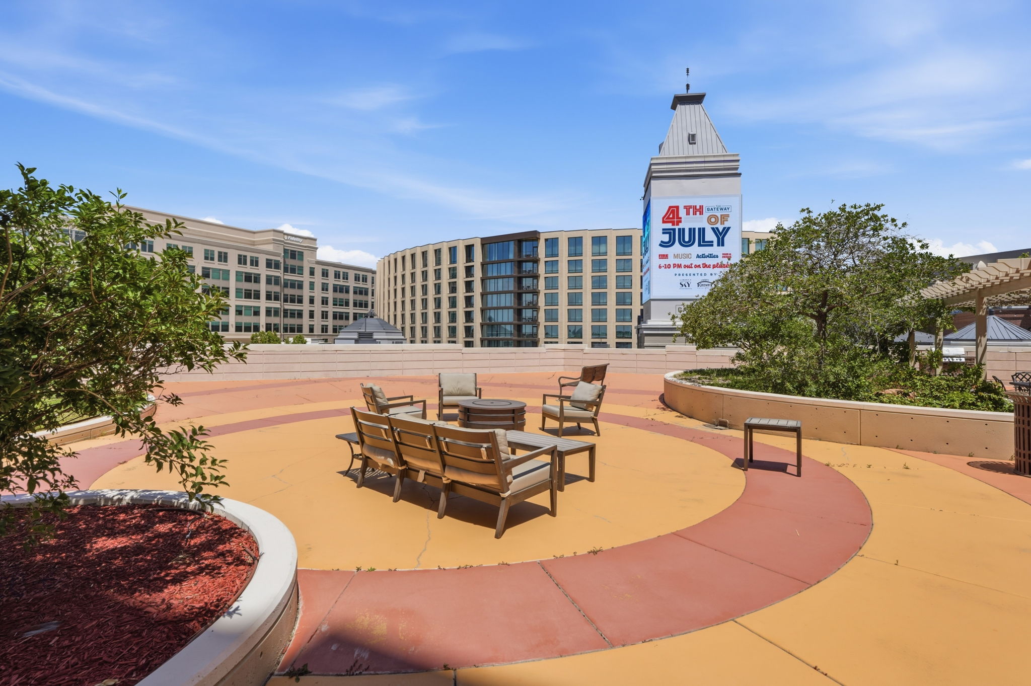 Rooftop patio with multi-toned concrete surfacing and integrated planters