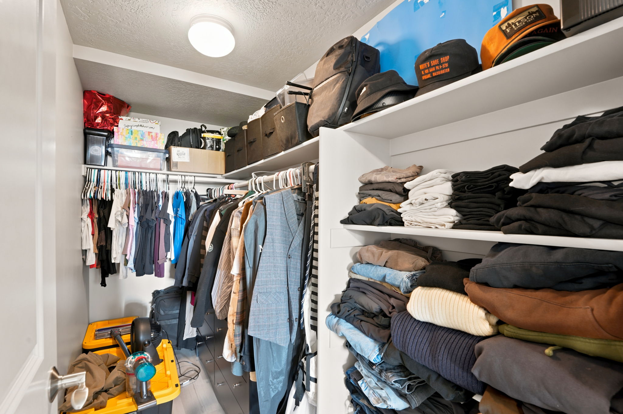 Built-in closet system featuring multiple hanging rods and extensive shelving