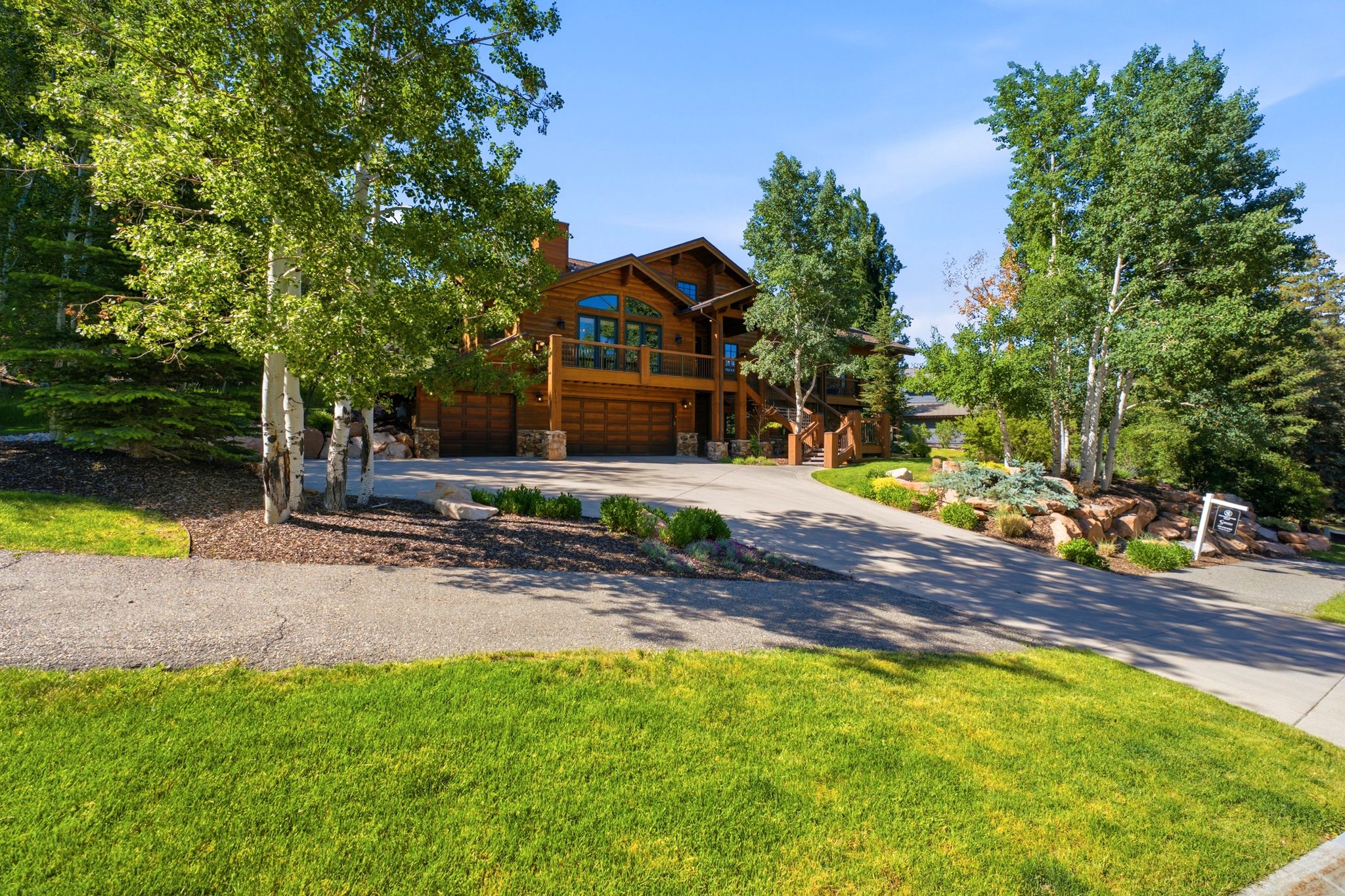 Mountain-style residence featuring a prominent wood exterior and stone accents