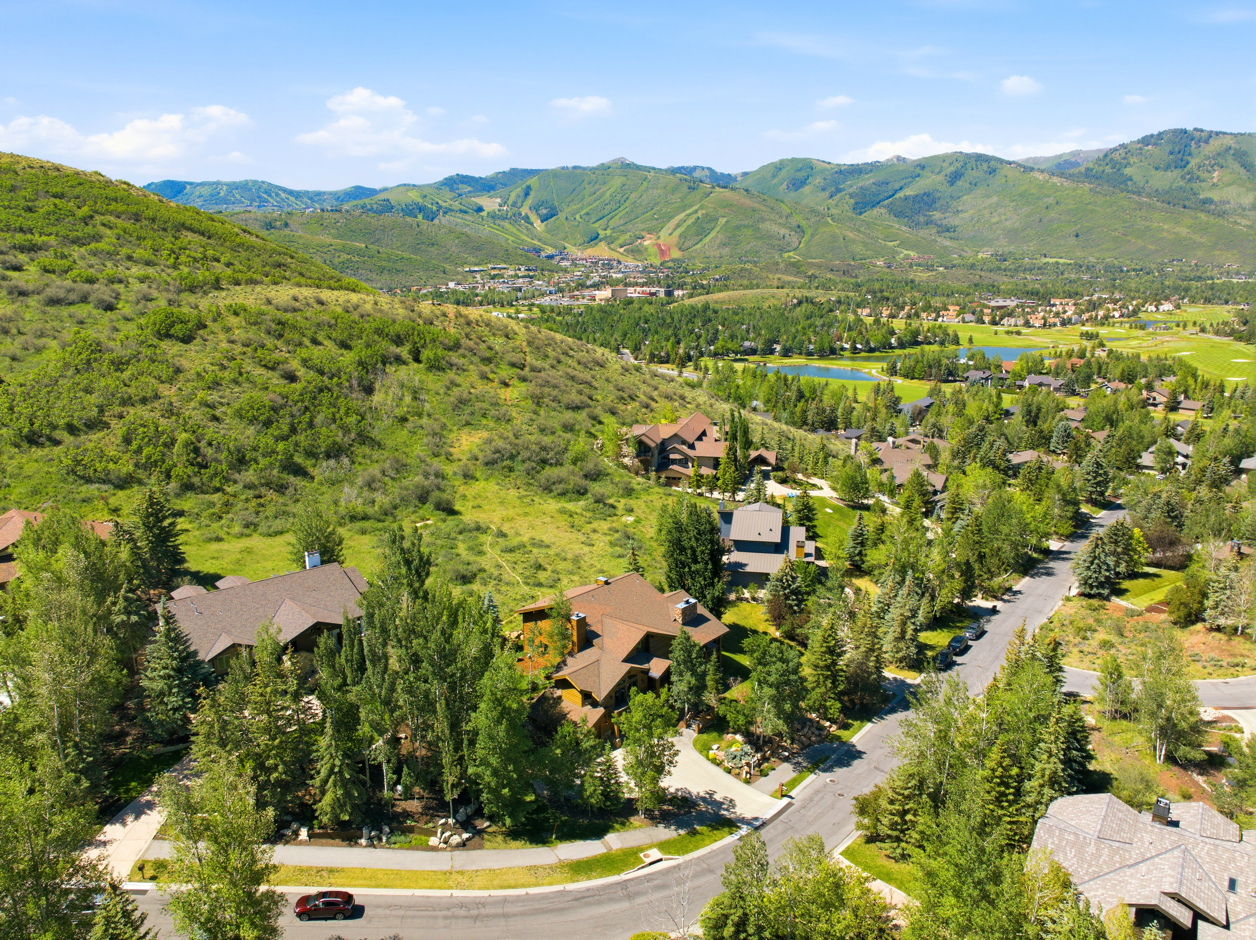 Residential community featuring custom homes, mature trees, and paved roads