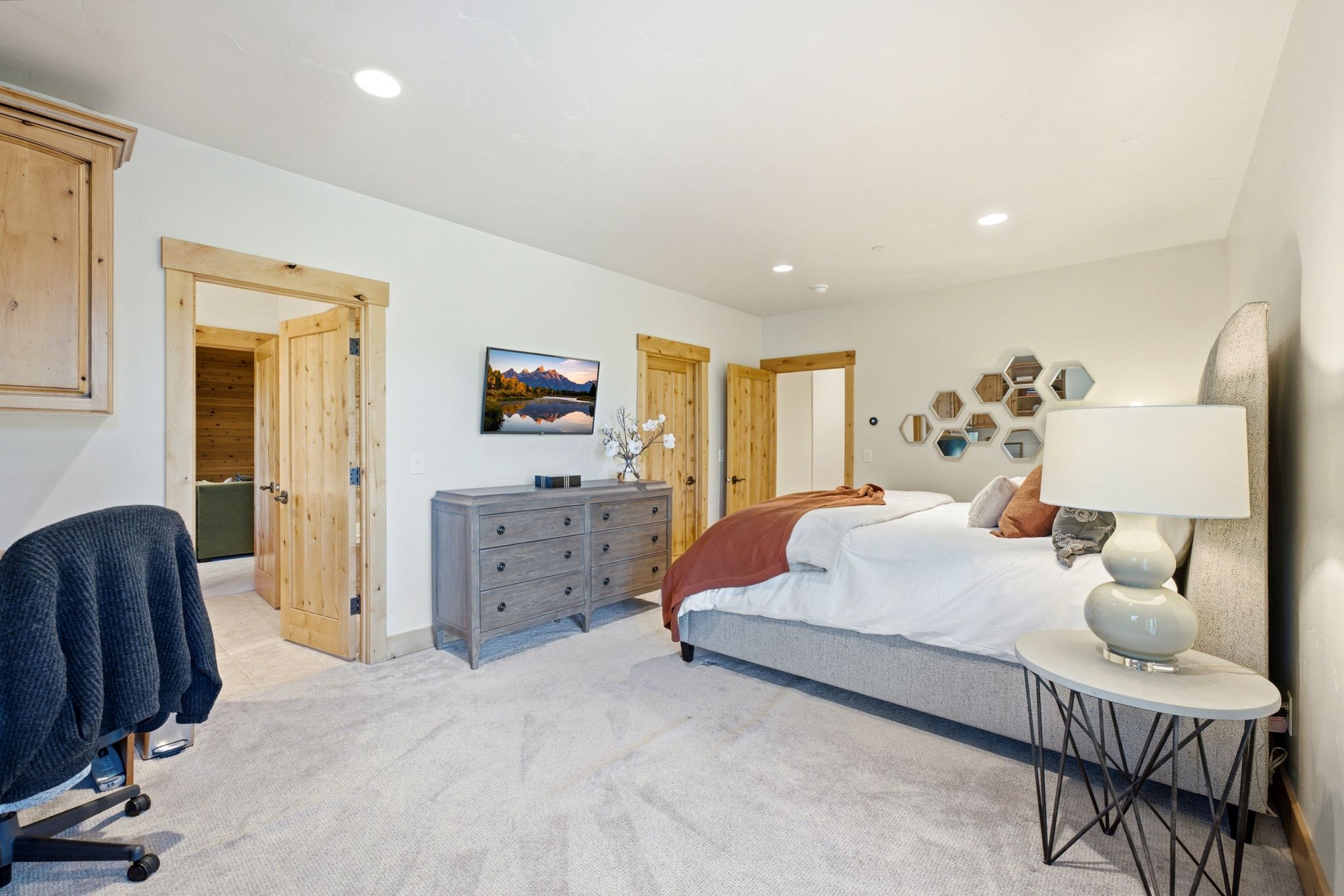 Spacious room featuring light-toned walls and plush carpeting