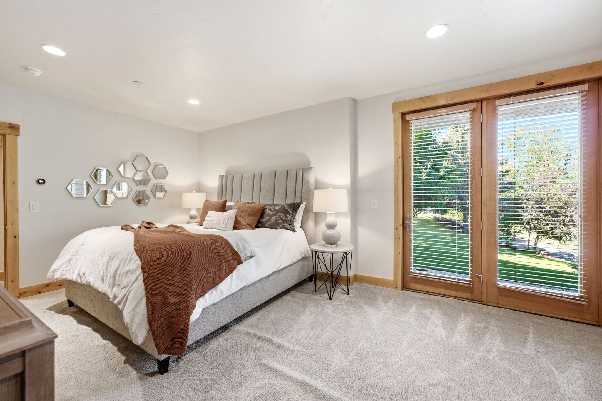 Bedroom featuring wood-framed glass doors, recessed lighting, light-toned walls, and soft grey carpeting