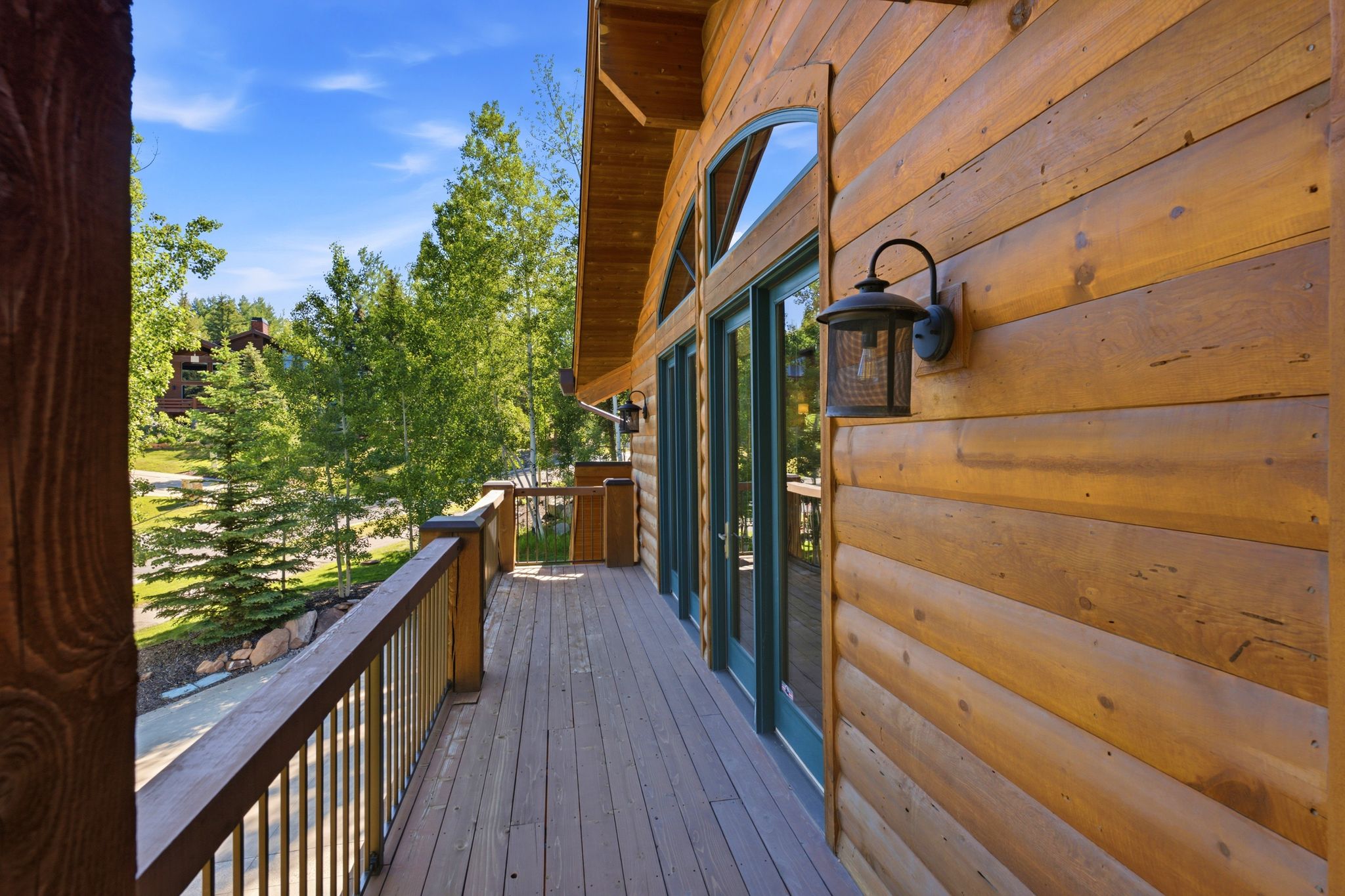 Expansive outdoor deck featuring wood-finish decking and railing
