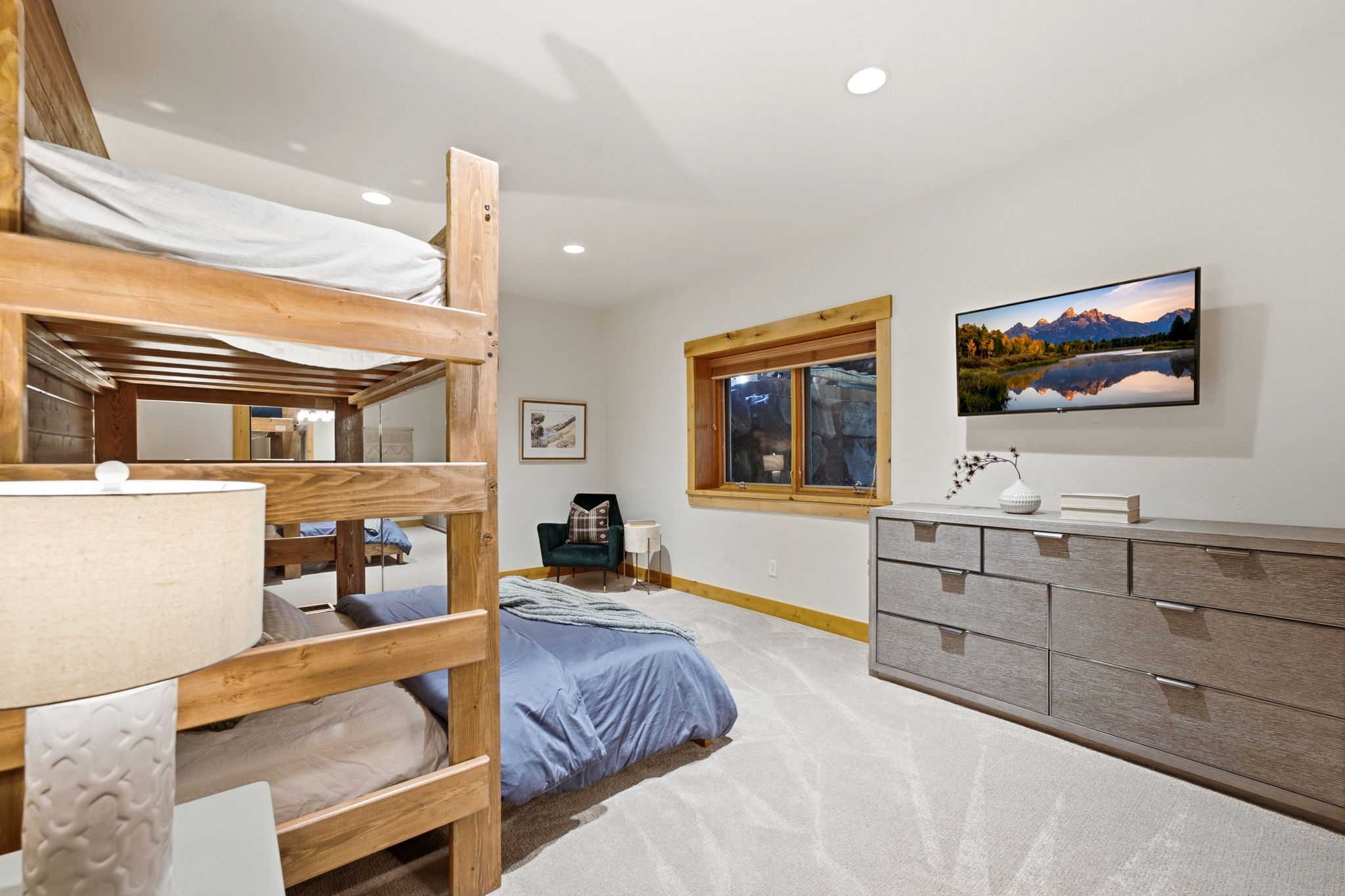 Bedroom featuring built-in bunk beds with wood framing, a wall-mounted television, and recessed ceiling lighting