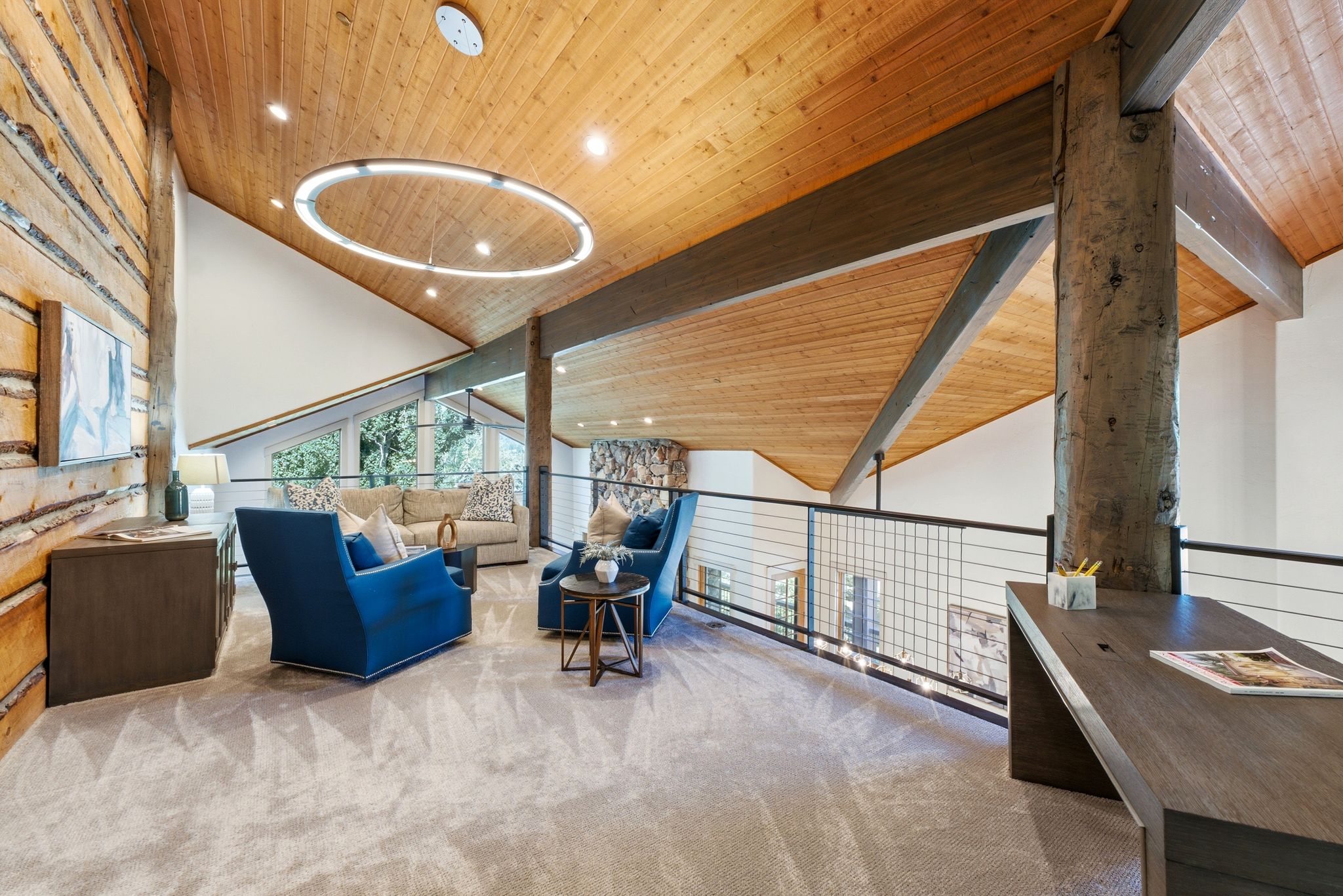 Vaulted wood-paneled ceiling with recessed lighting and a circular chandelier