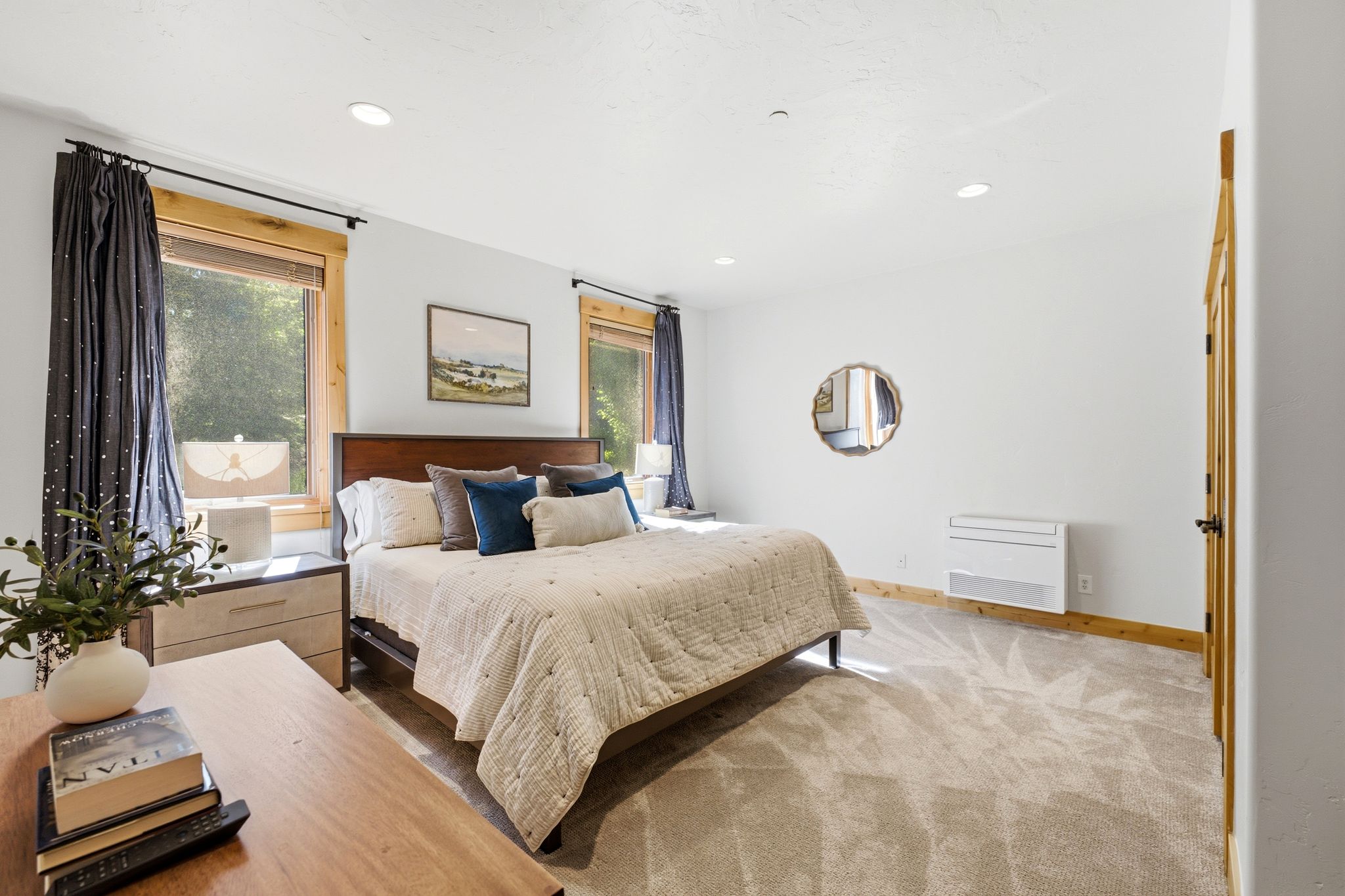 Carpeted bedroom featuring recessed lighting and natural wood window trim