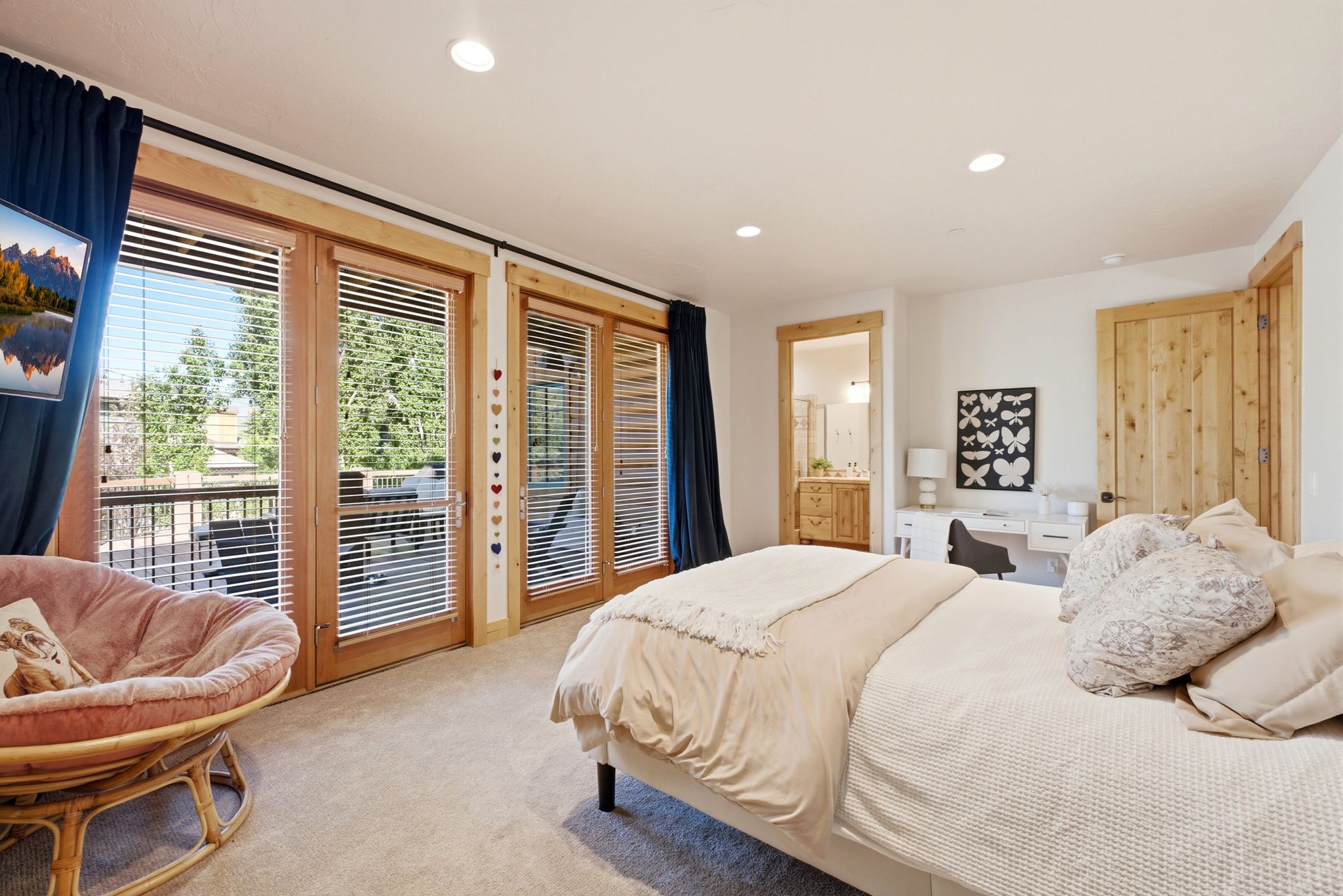 Bedroom featuring three French doors with wood trim, recessed lighting, and soft pile carpeting