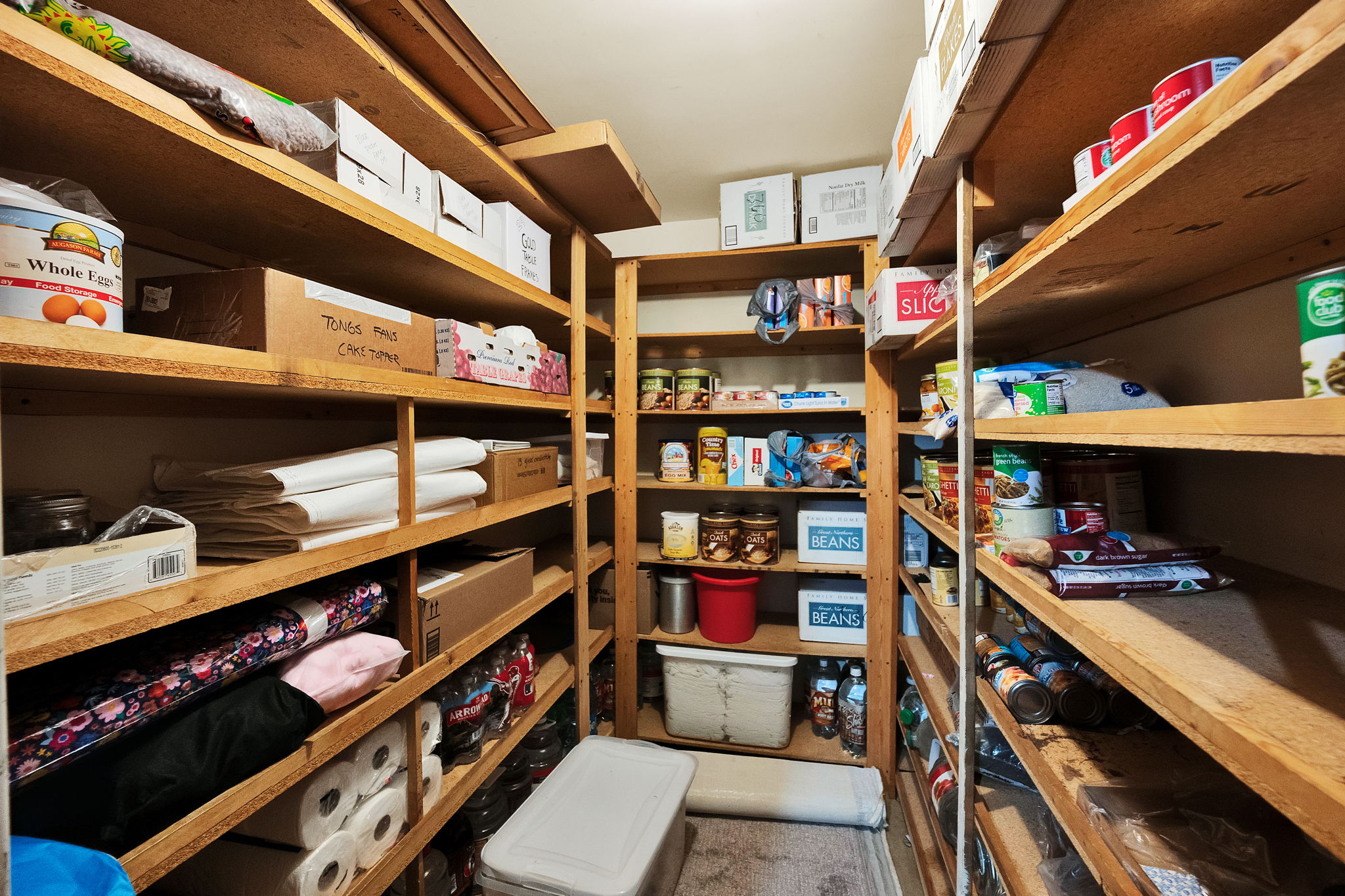 Dedicated storage room featuring extensive built-in shelving