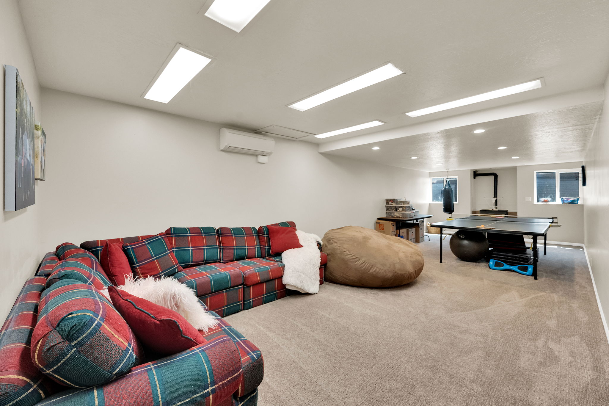 Versatile lower-level space featuring light beige carpeting and white walls