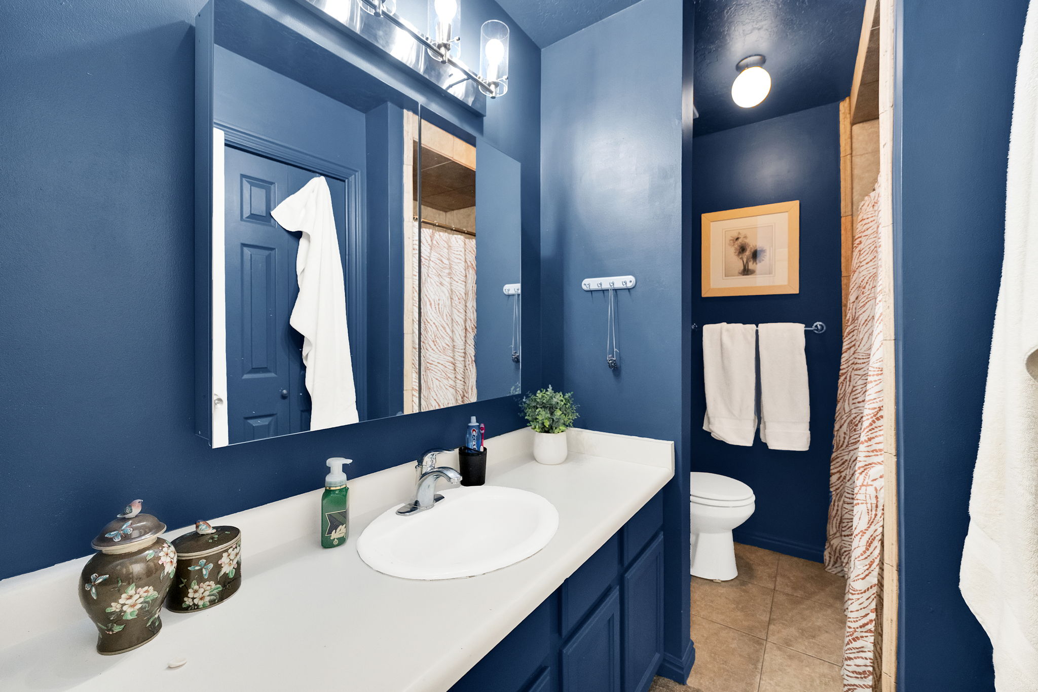 Bathroom vanity featuring an integrated sink, polished chrome faucet, and ample counter space