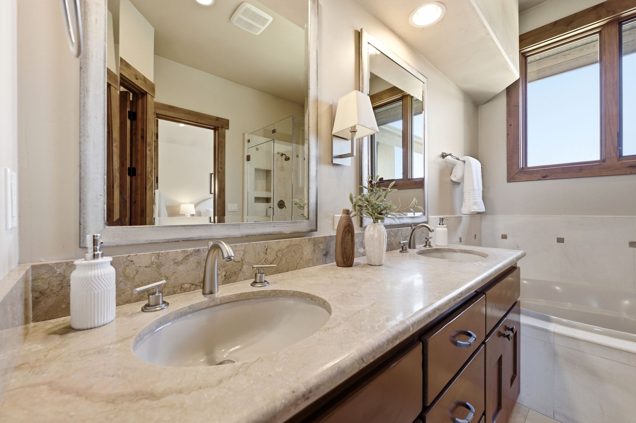 Double vanity with light-toned countertop, dual undermount sinks, and brushed nickel faucets
