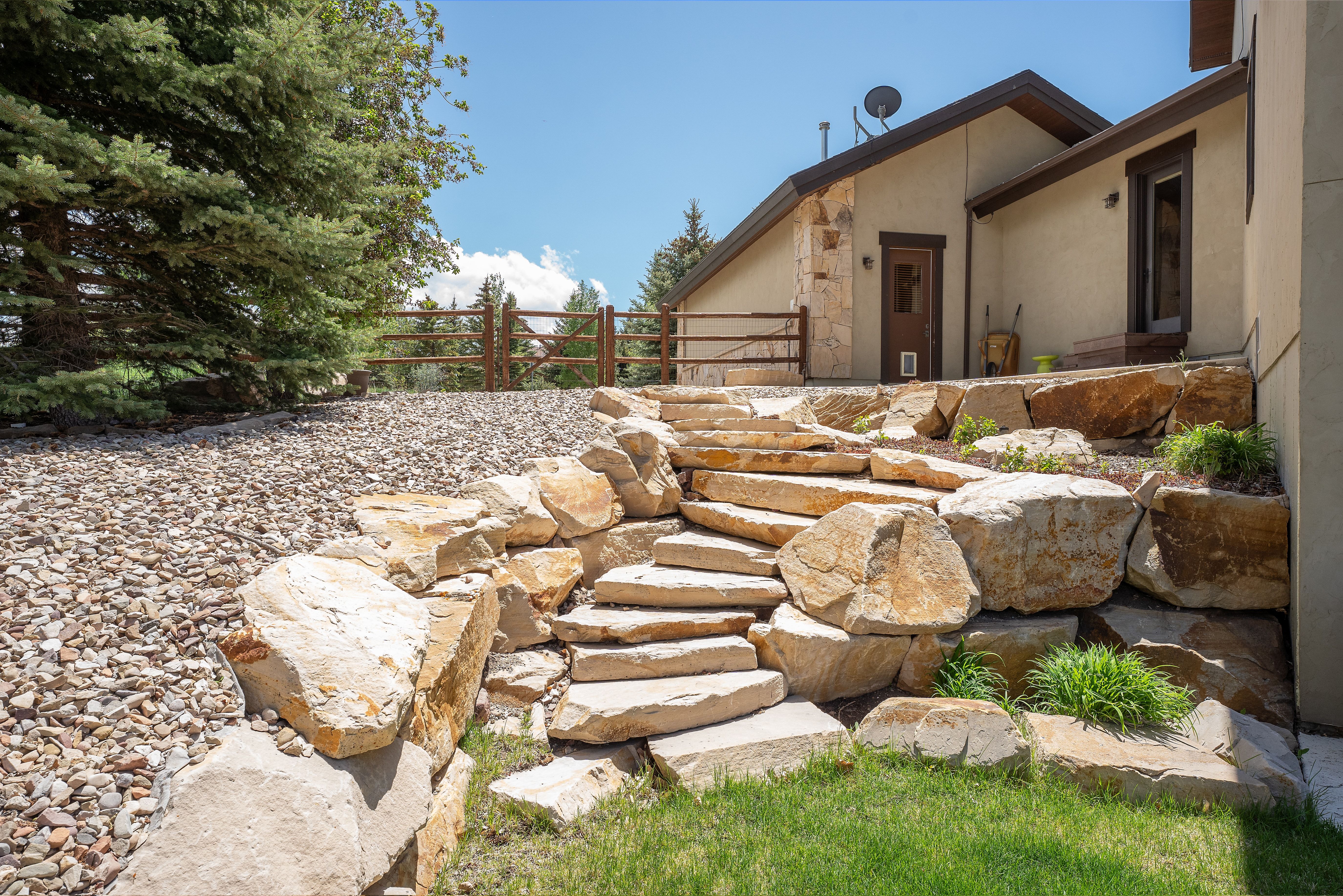 Stone staircase and retaining walls with integrated plantings