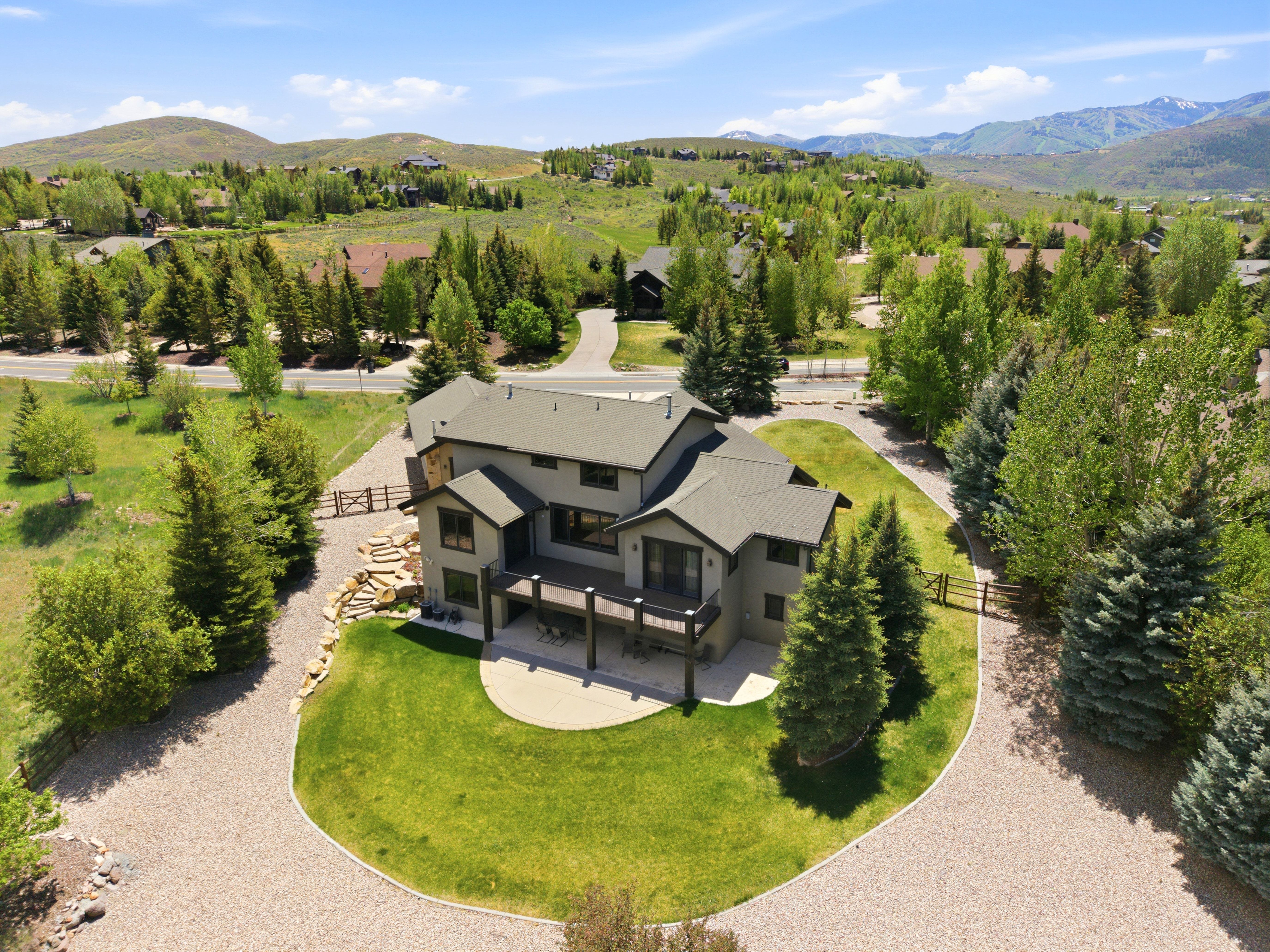 Contemporary residence featuring a multi-level deck and stone accents