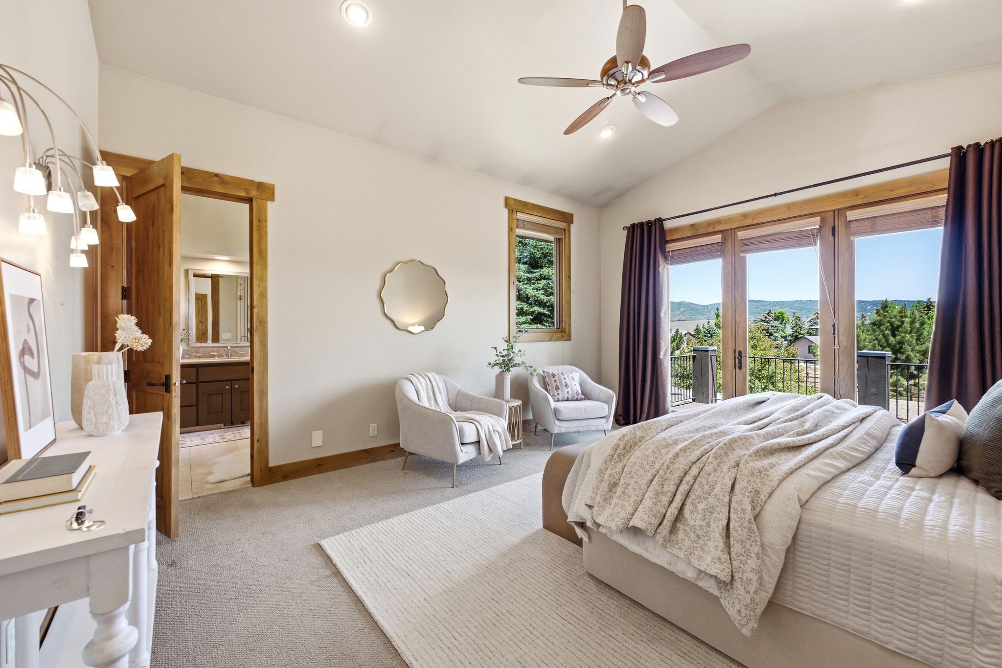 Vaulted ceiling with an integrated ceiling fan, recessed lighting, and a large window