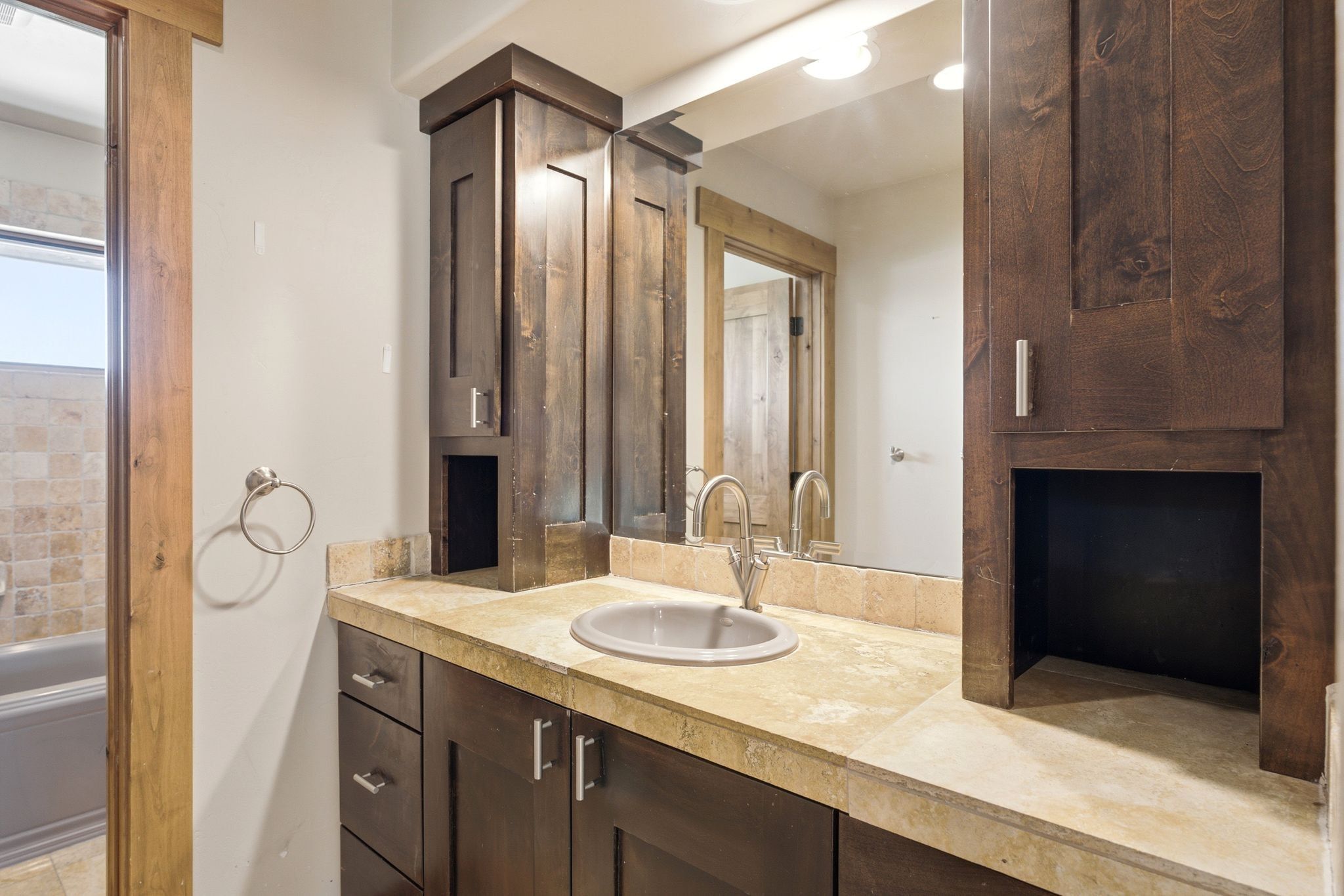 Vanity featuring a light-toned countertop, an undermount sink, and a chrome faucet