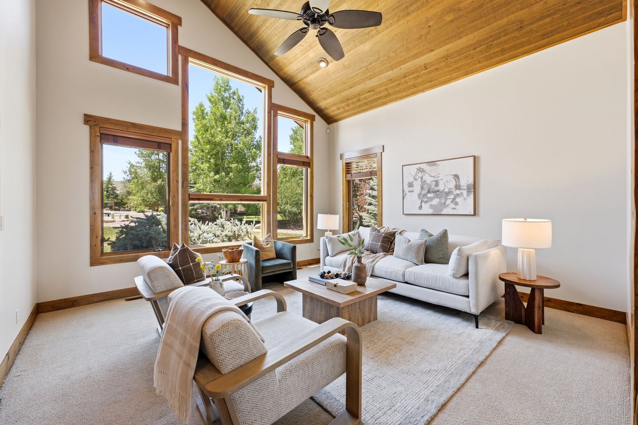 Vaulted ceiling with wood-finish paneling and exposed wood beams