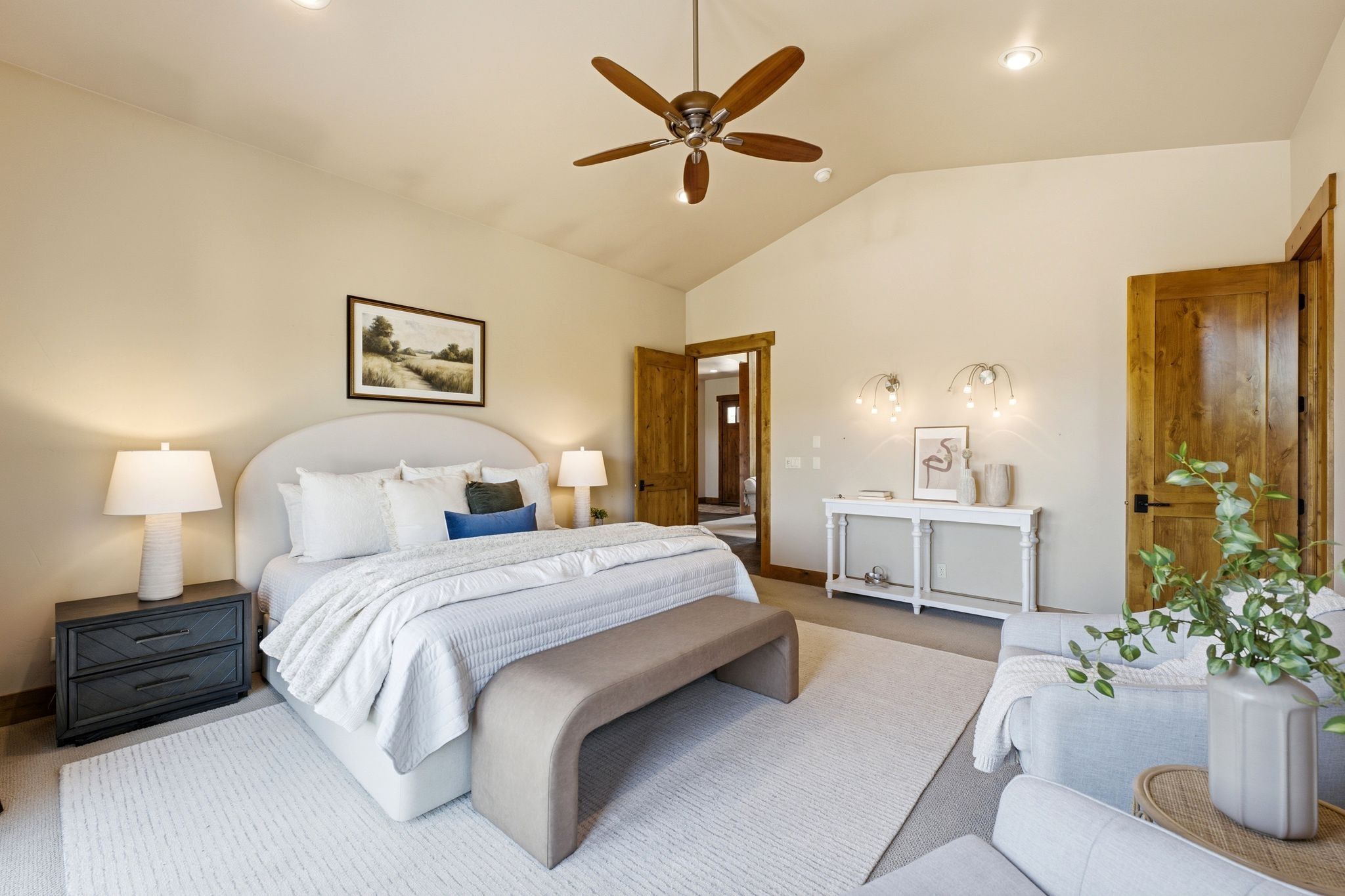 Vaulted ceiling with a wood-finish ceiling fan, recessed lighting, and light neutral wall paint