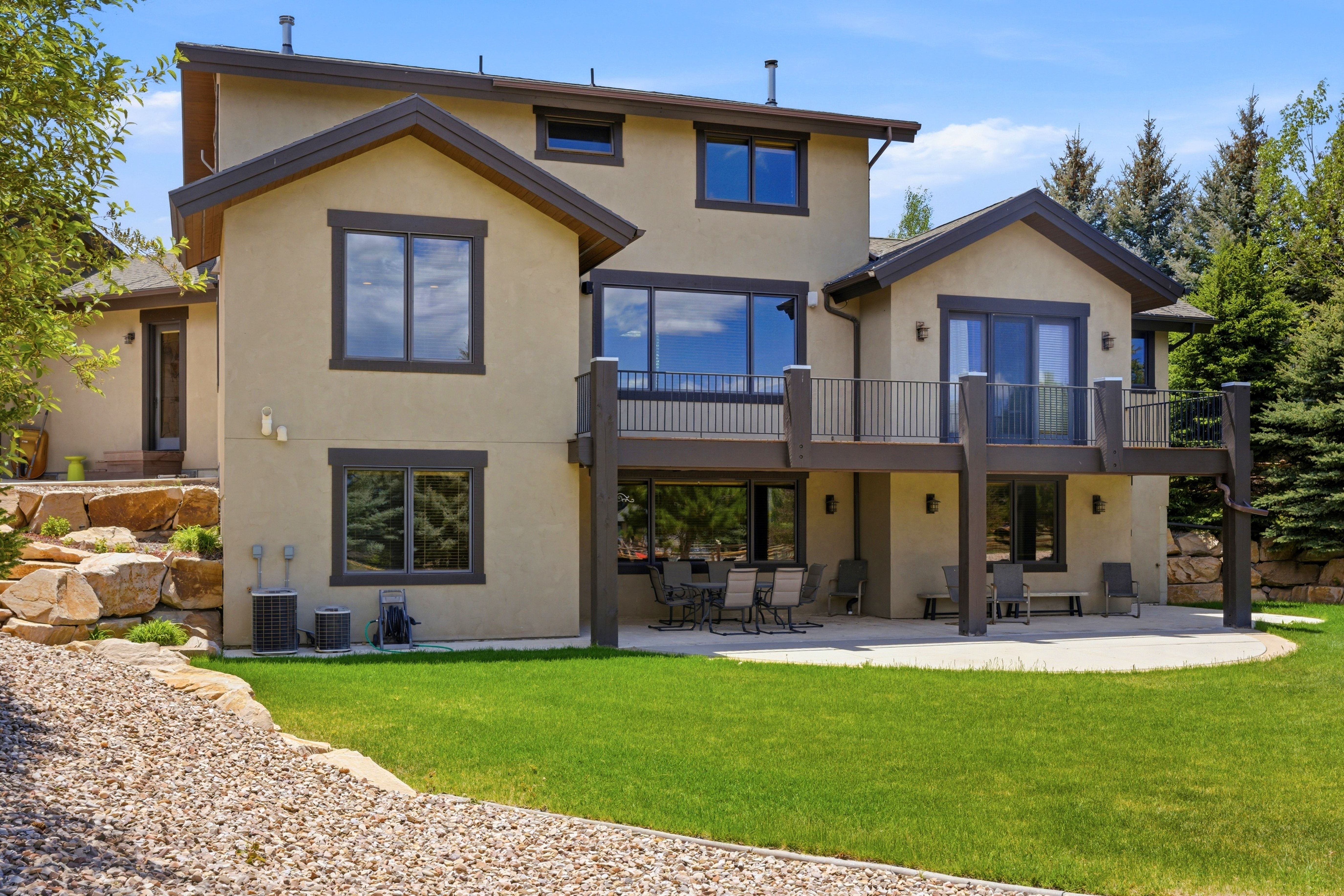 Rear exterior featuring a stucco facade and multiple windows
