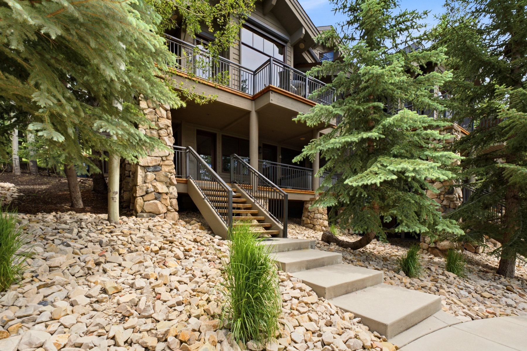 Multi-level exterior featuring stone accents and dark wood siding
