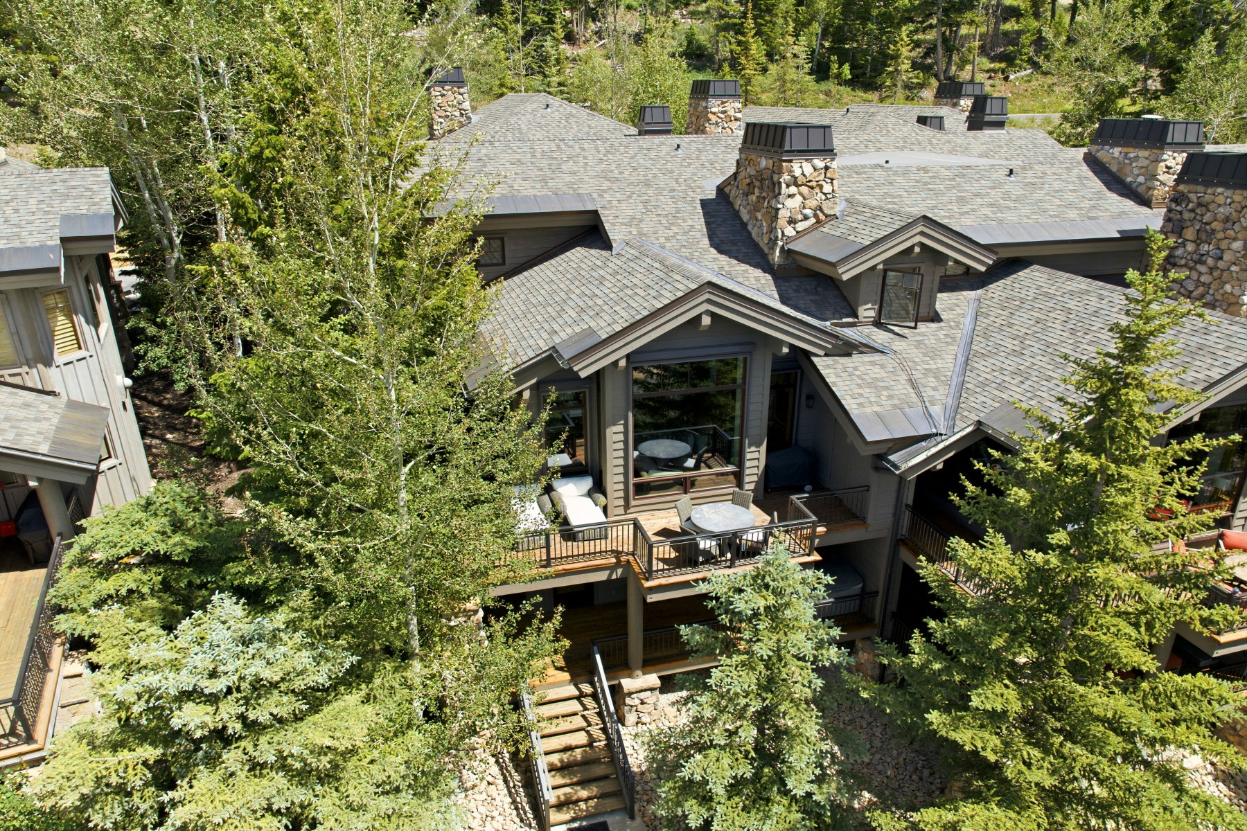 Multi-level property featuring a stone and wood exterior