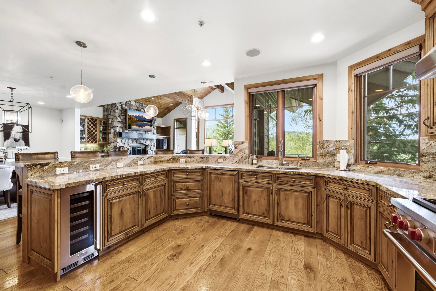 Spacious kitchen featuring wood-finish cabinetry, light-toned countertops, and wood-finish flooring