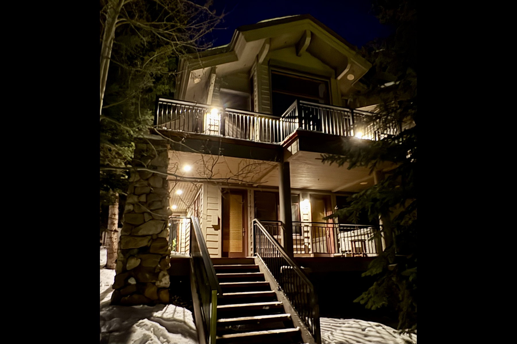 Multi-level property with balconies and exterior lighting