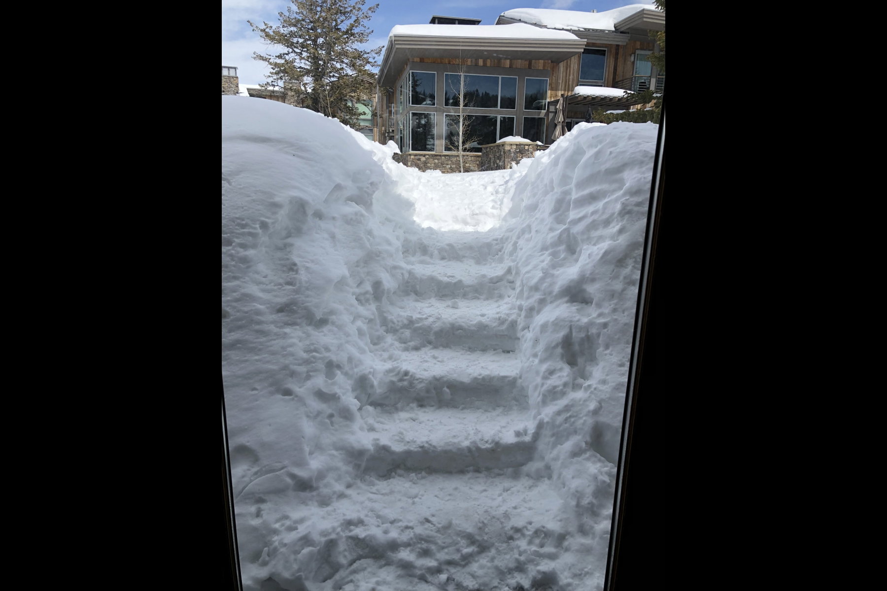 Expansive snow-covered path featuring carved steps