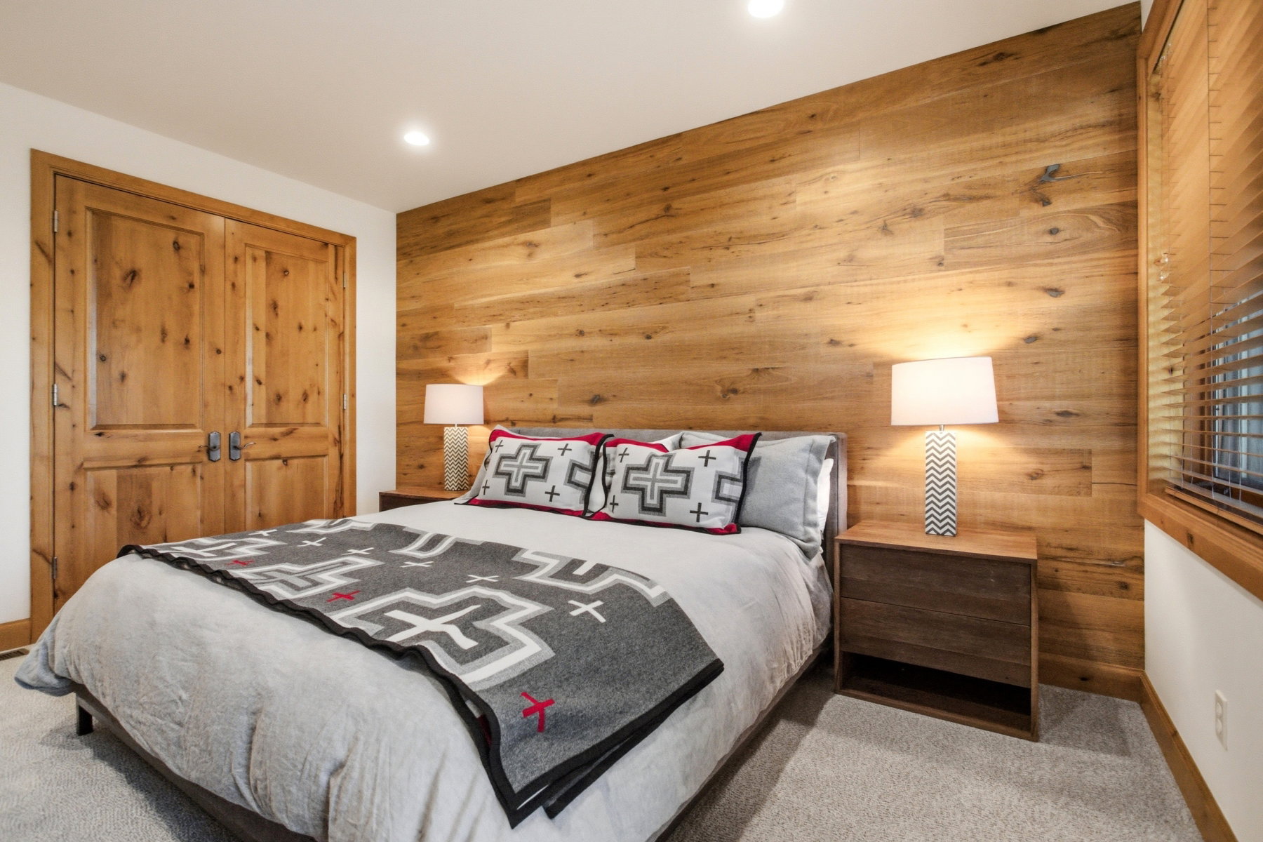 Wood-paneled accent wall with recessed lighting