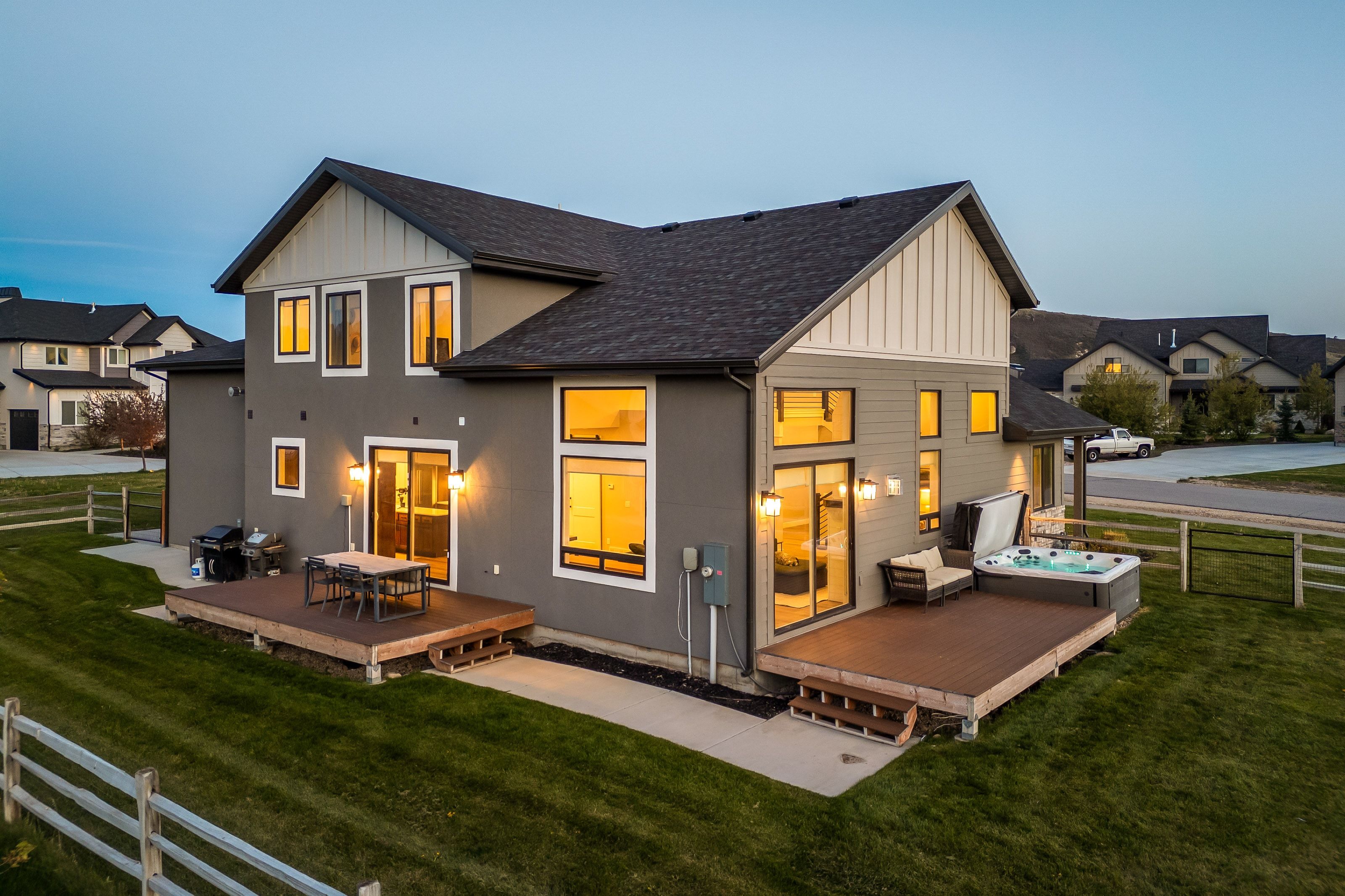 Contemporary exterior with multiple decks, a hot tub, and sliding glass doors