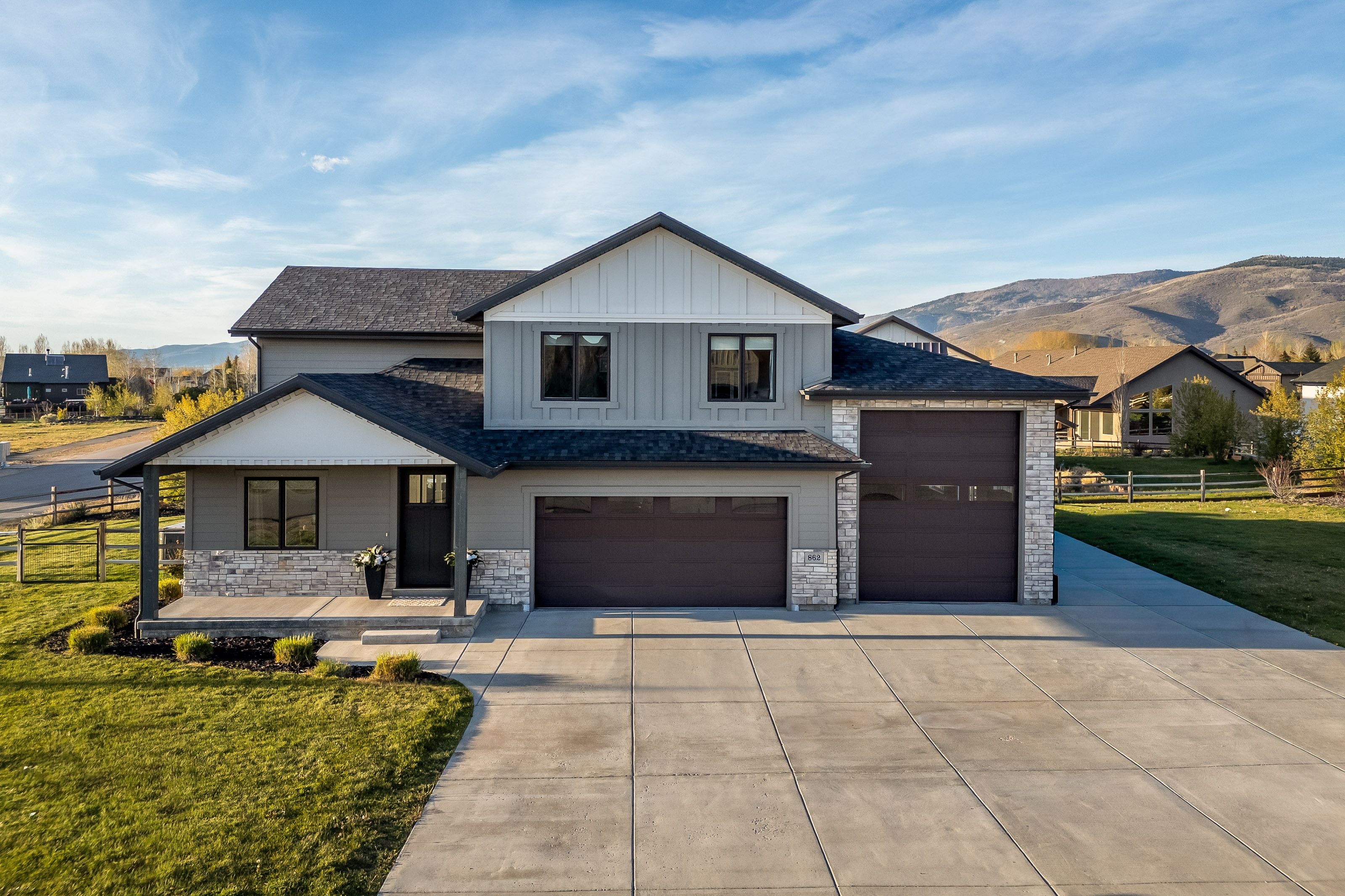Contemporary two-story residence with a multi-gabled roofline and a neutral color palette